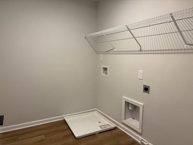 Spacious laundry room with white wire shelving, washer dryer hookups and floor drain in Davidson Homes Cary A, Winder GA