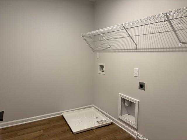 Spacious laundry room with white wire shelving, washer dryer hookups and floor drain in Davidson Homes Cary A, Winder GA