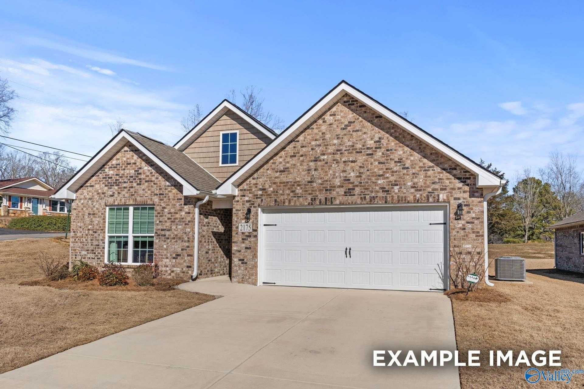 Modern brick single-story home with 2-car garage and gabled roof in Flint Meadows, New Market, Alabama