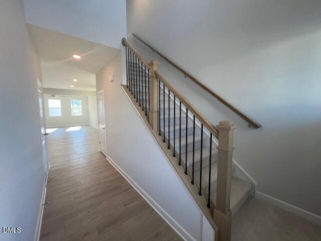 Elegant two-story staircase with wrought iron balusters and oak handrail in 4-bedroom Adalynn B home, Lillington, NC