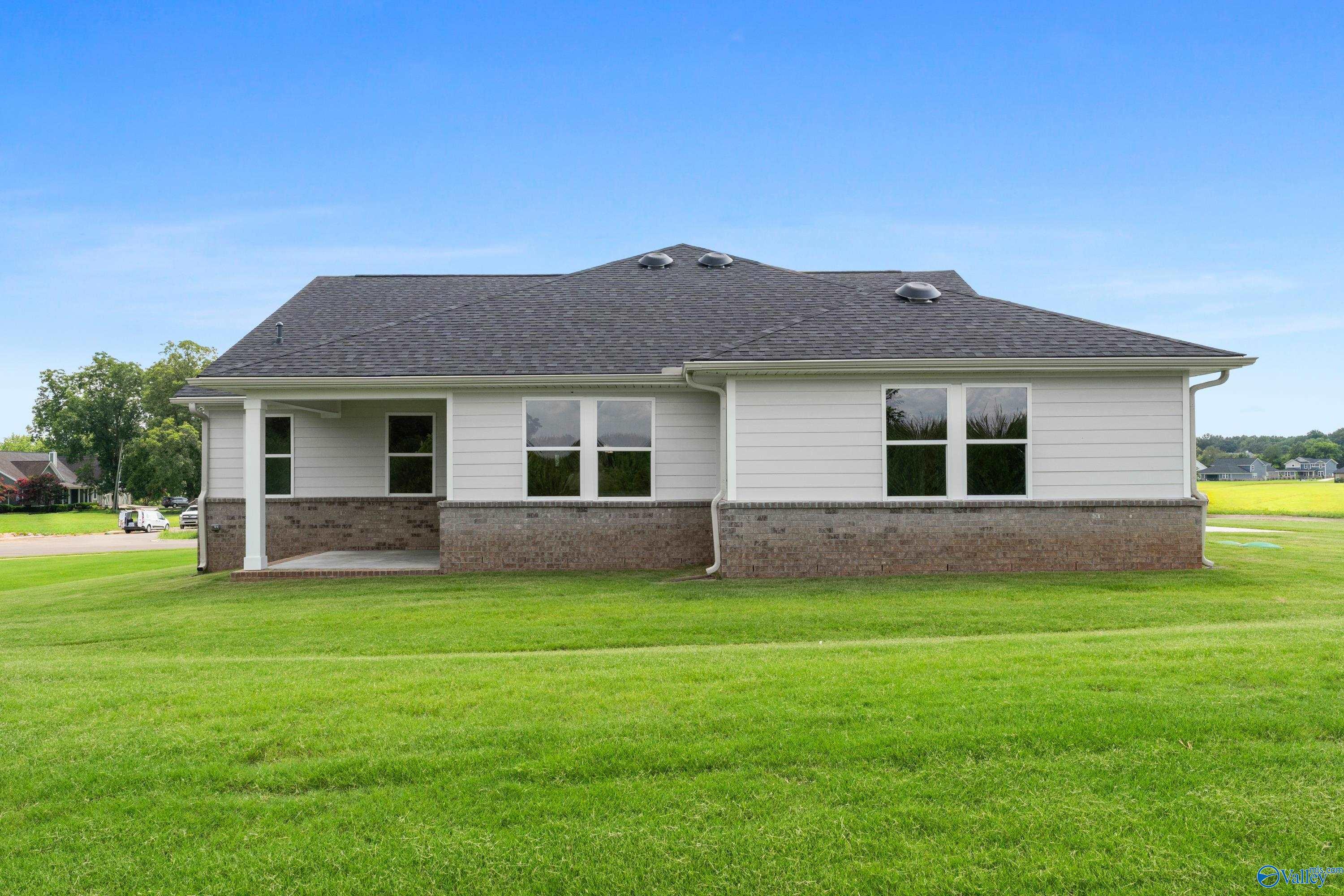 Single-story Arcadia home exterior with brick base, covered porch, and large windows in Riverton Preserve, Huntsville, Alabama