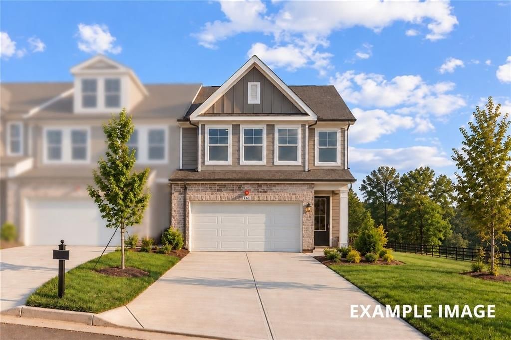Two-story brick and siding exterior with 2-car garage and landscaped yard at The Durham D by Davidson Homes in Cumming, GA