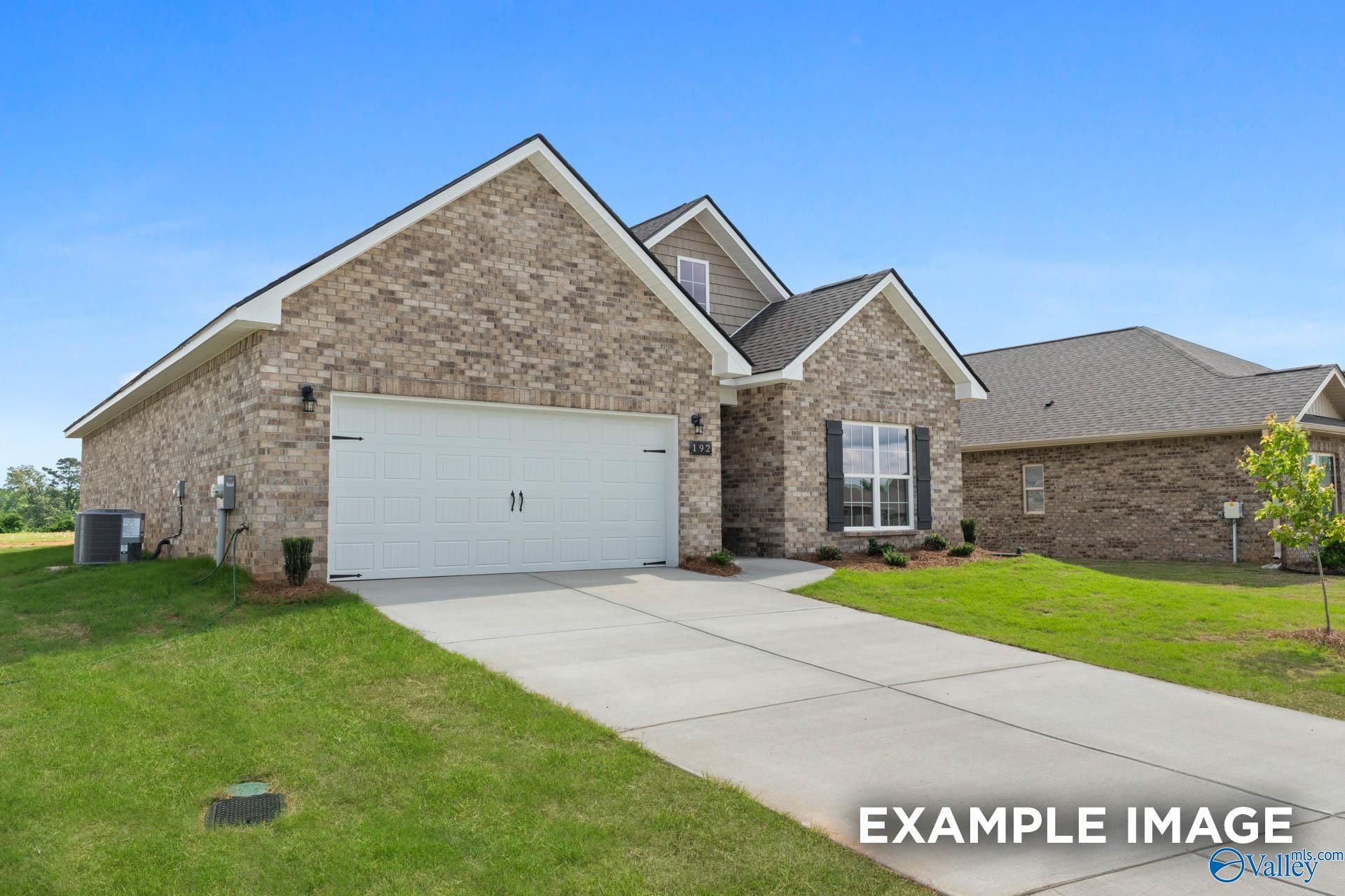 Brick exterior of The Franklin C floor plan by Davidson Homes with 2-car garage in Heritage Lakes, New Market, Alabama.