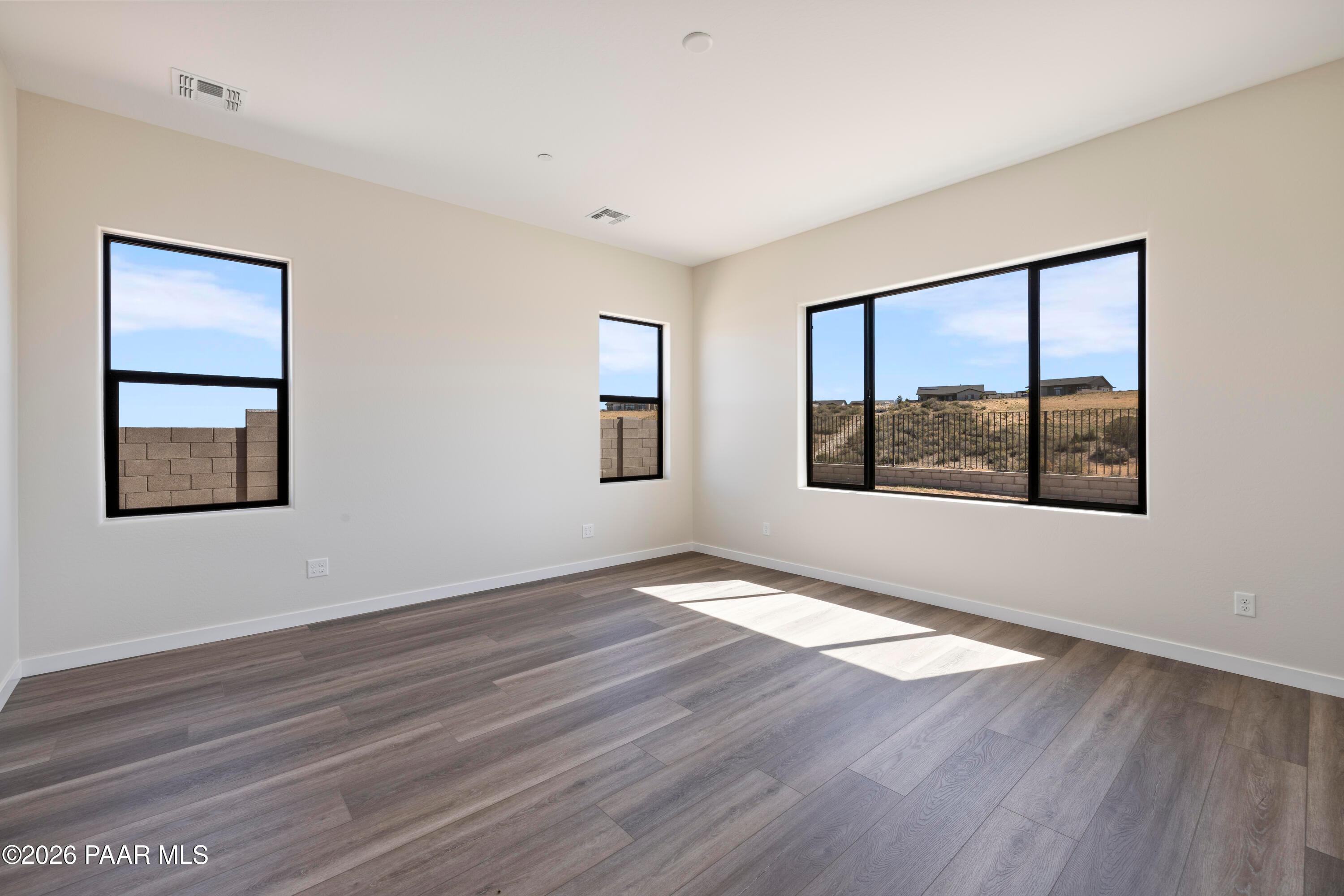 Bright living room with large windows showcasing desert mountain views in 3-bedroom Prescott Arizona home