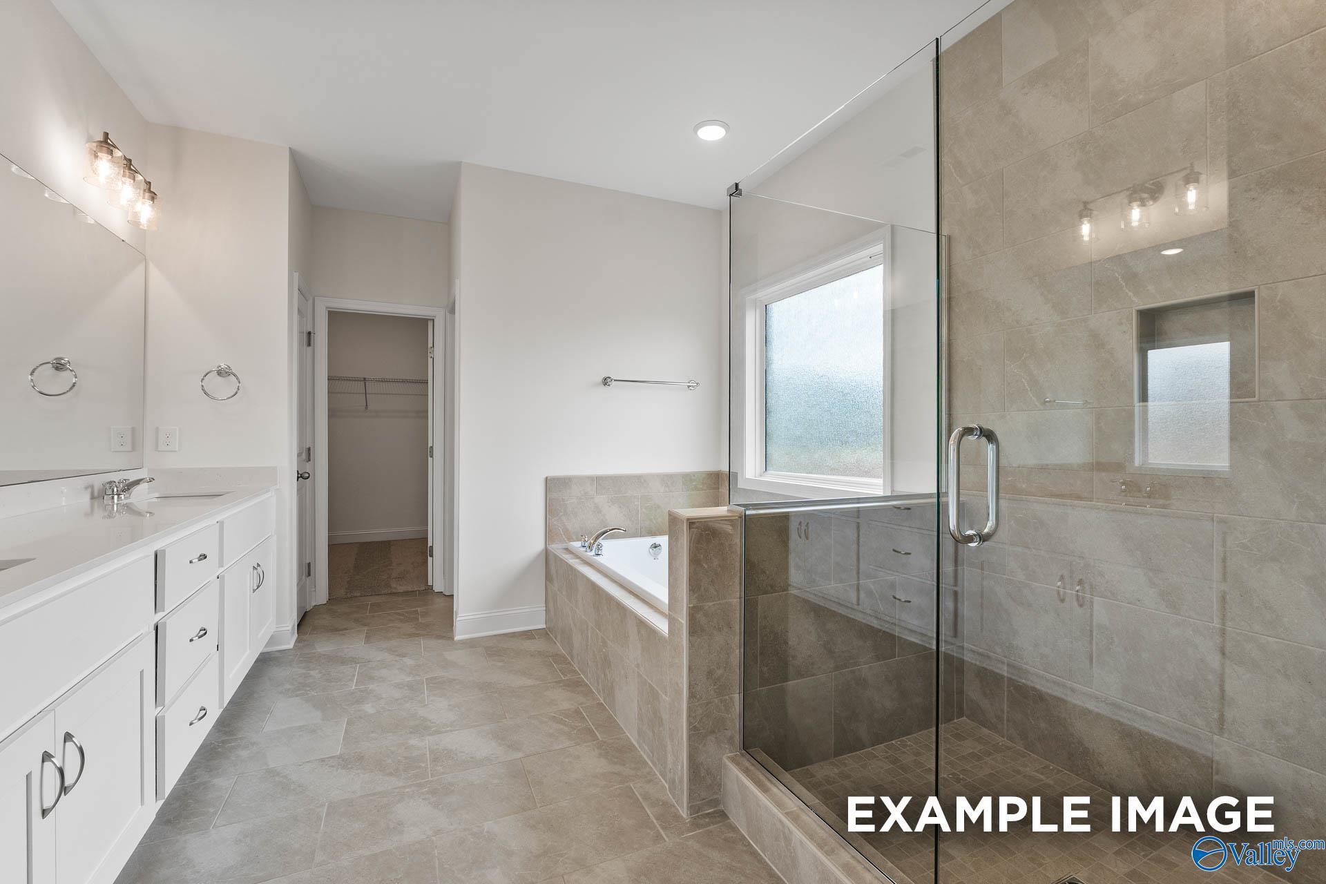 Luxurious master bathroom with double vanity, glass shower, freestanding tub in Davidson Homes The Oxford A, Meridianville, Alabama
