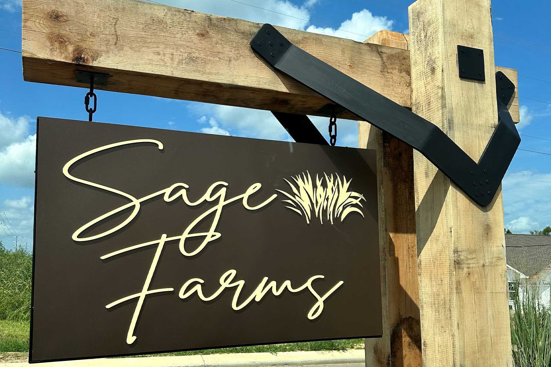 Rustic wooden Sage Farms entrance sign in White House Tennessee with elegant white lettering and sage grass emblem
