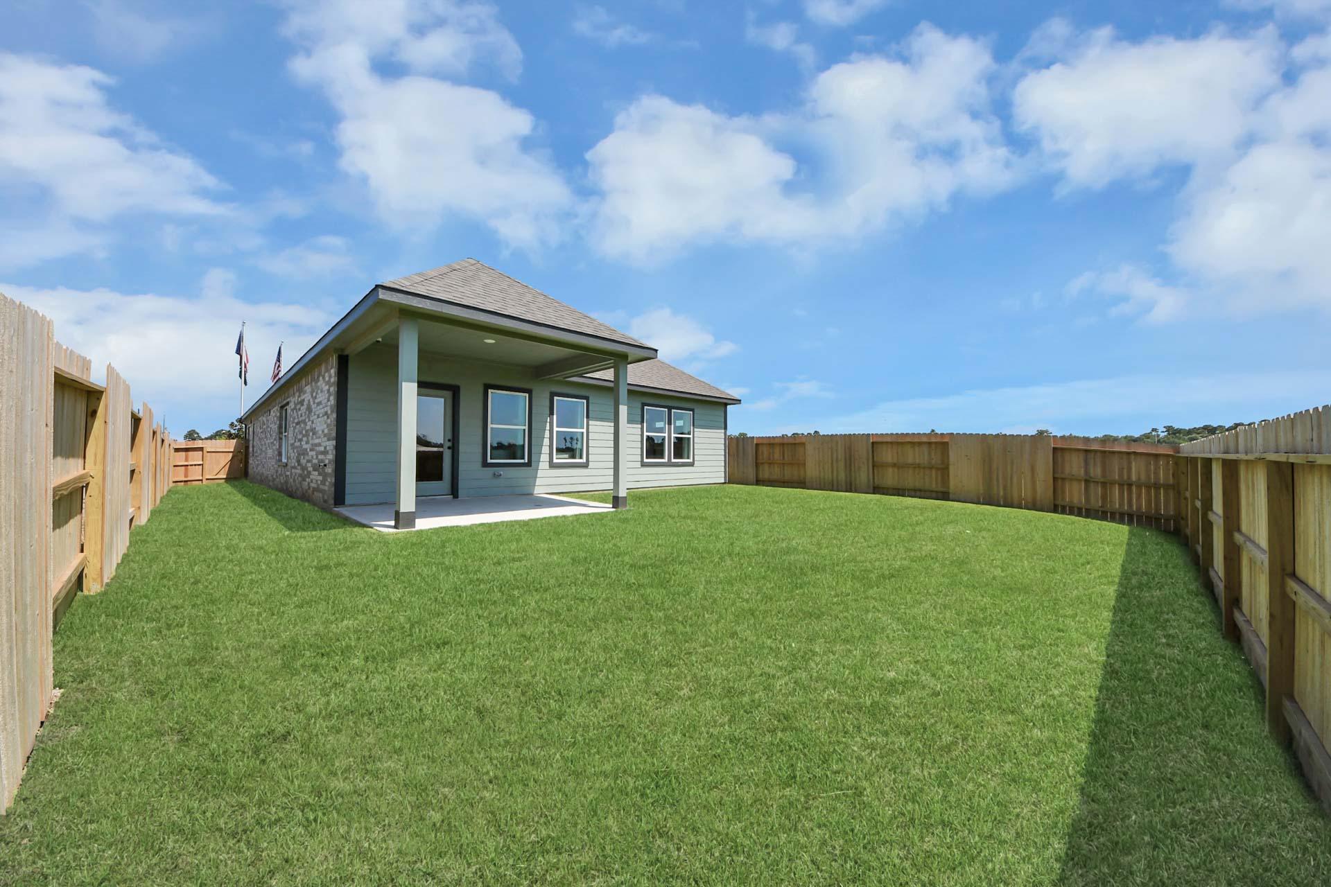 Spacious backyard with covered patio at Enclave at Newport in Crosby, TX, built by Davidson Homes.