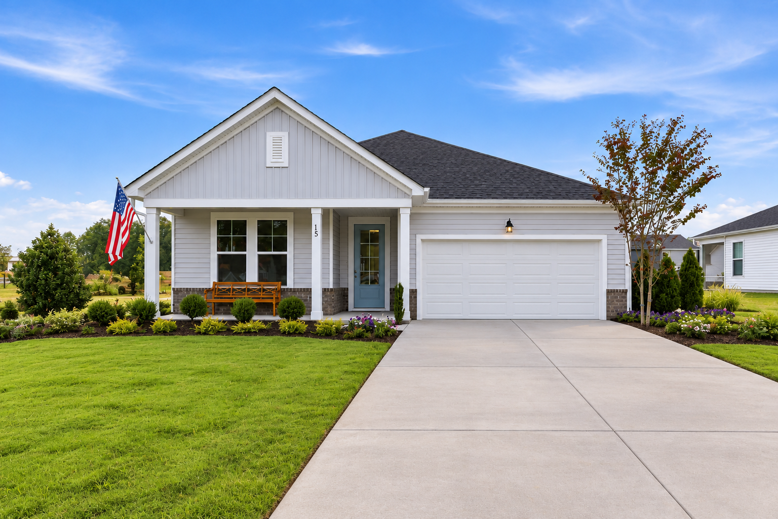 Single-story ranch home exterior at Retreat at North Main in Lillington, NC with covered porch, two-car garage, and landscaped yard