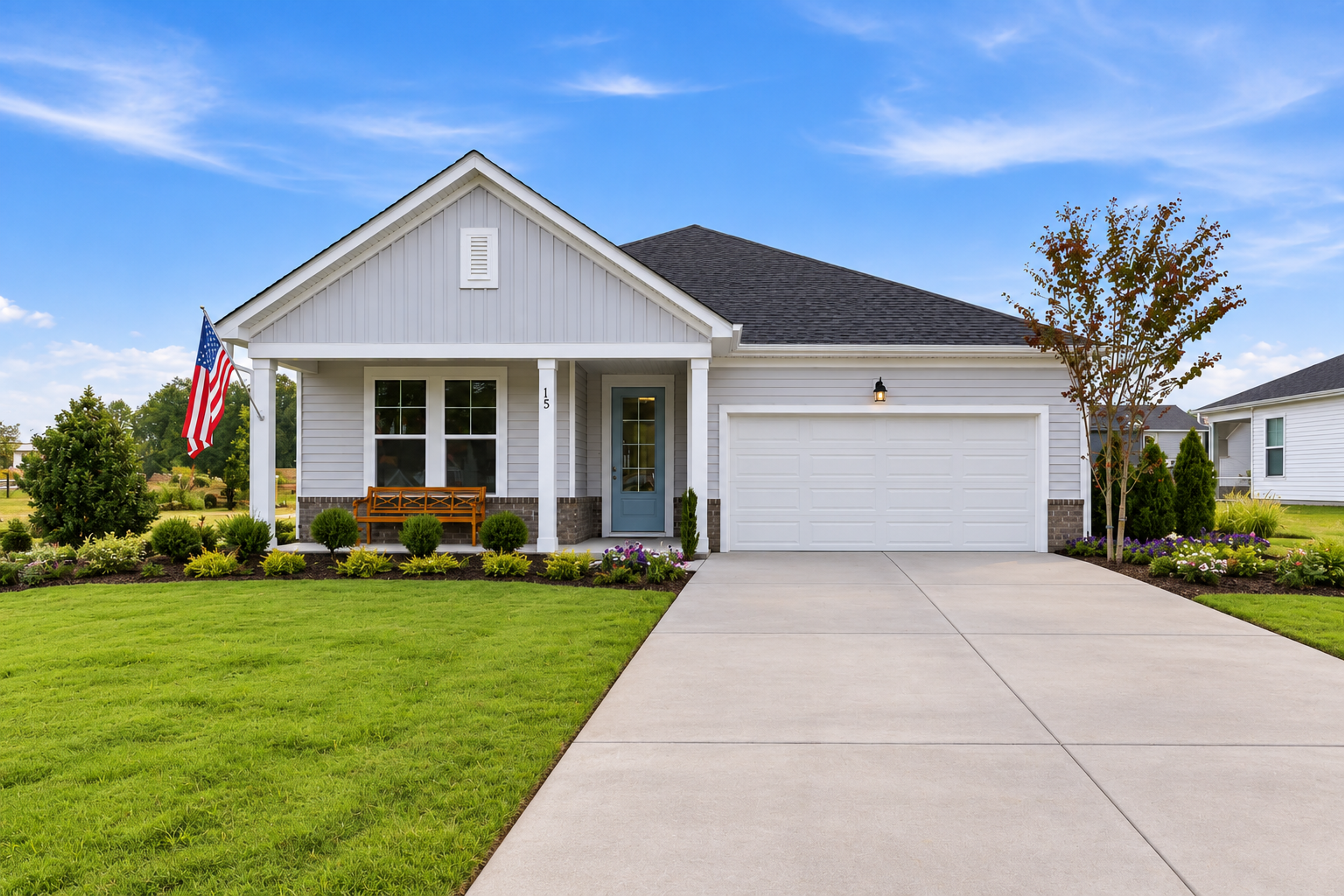 Single-story ranch home exterior at Retreat at North Main in Lillington, NC with covered porch, two-car garage, and landscaped yard