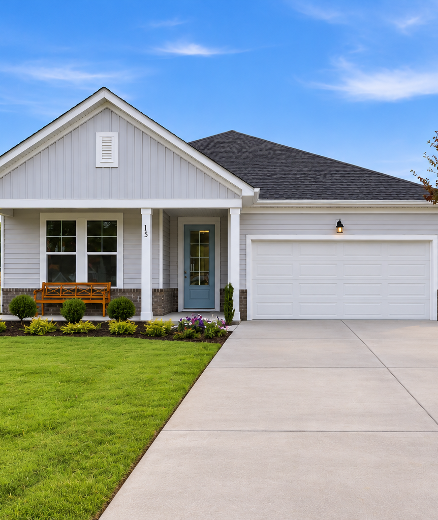 Single-story ranch home exterior at Retreat at North Main in Lillington, NC with covered porch, two-car garage, and landscaped yard