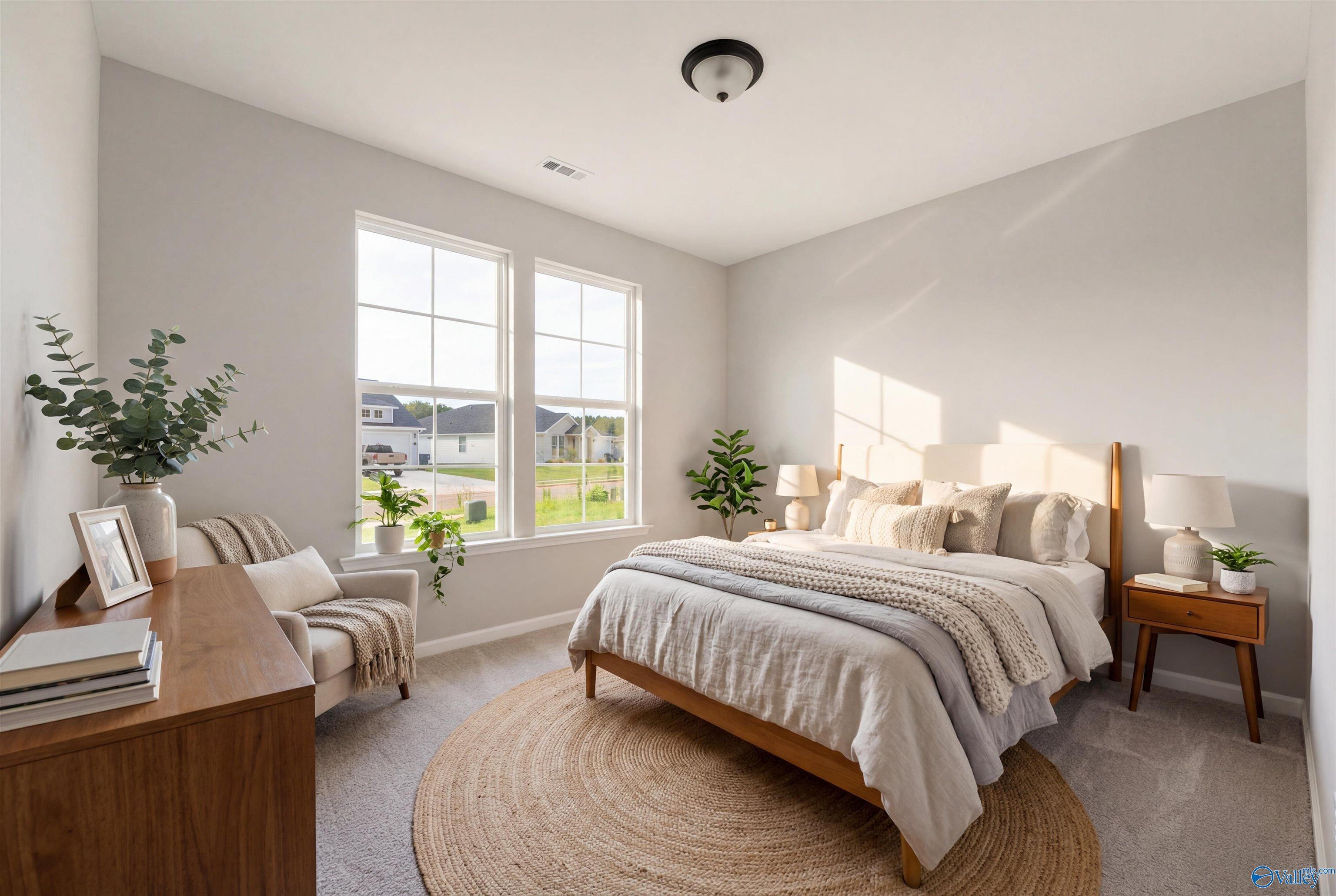 Cozy bedroom with neutral bedding, wooden nightstands, potted plants, and natural light in Davidson Homes The Phoenix, Hazel Green, Alabama