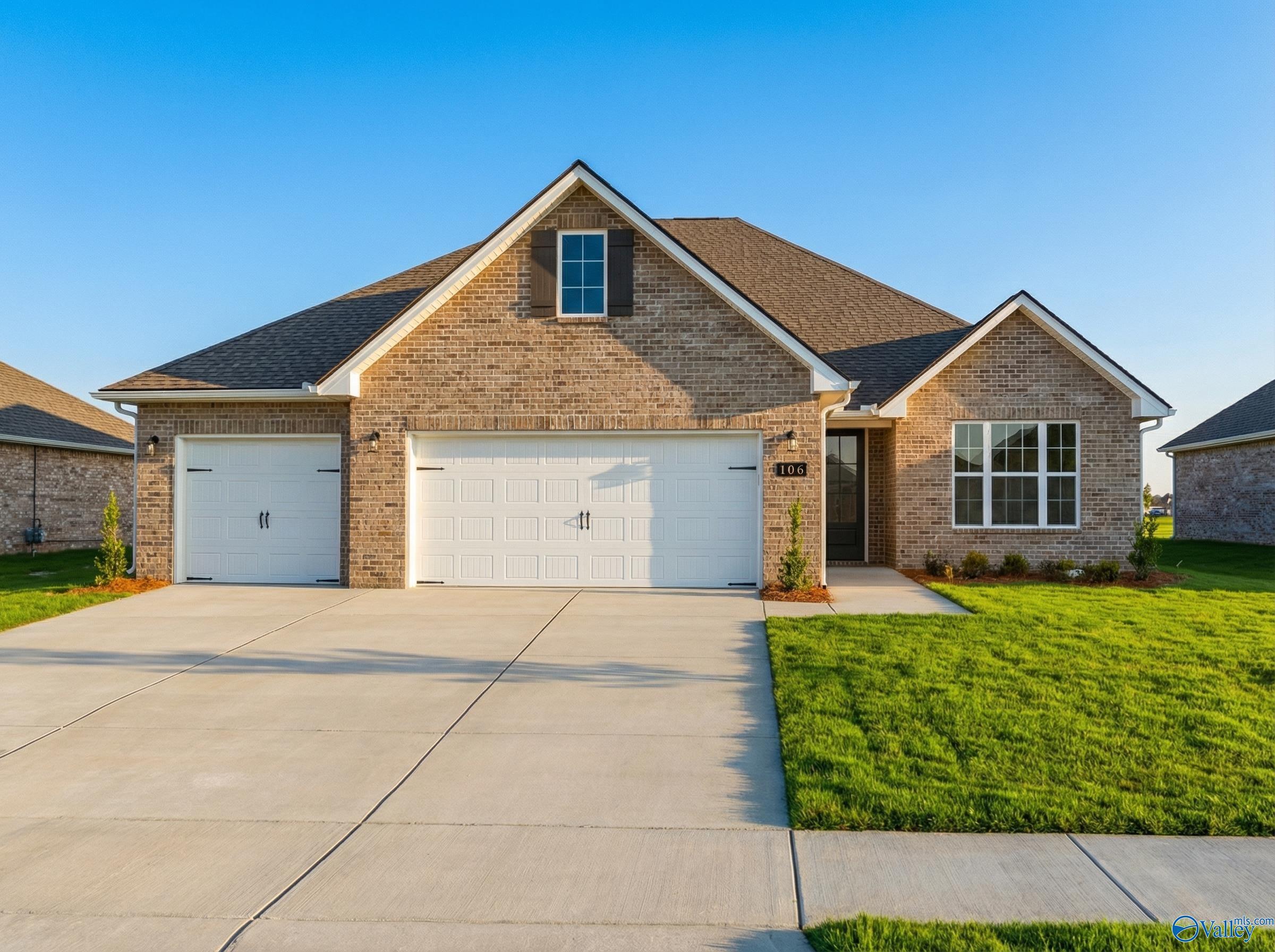 Modern brick 1-story home with 3-car garage, gabled roof, and landscaped yard in Pikes Ridge, Meridianville, Alabama - Davidson Homes The Lanier
