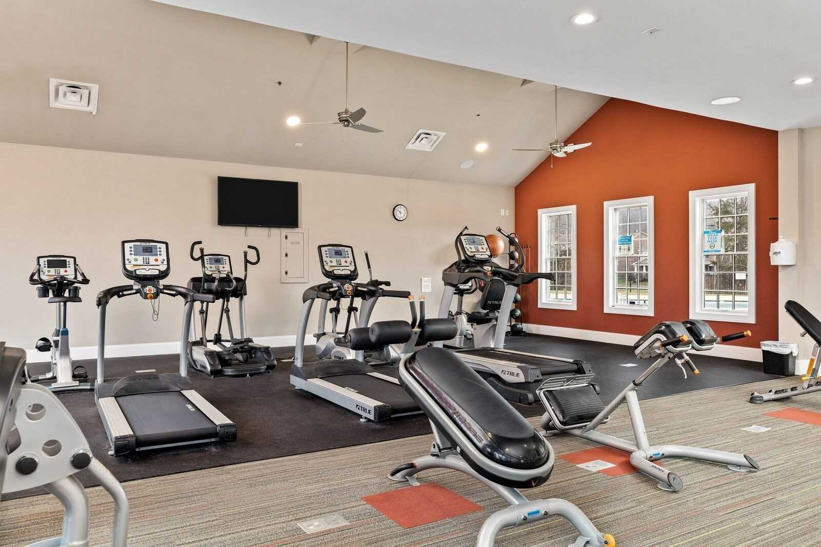 Modern fitness center with treadmills, ellipticals, weights, and large windows in Carellton, Gallatin, Tennessee