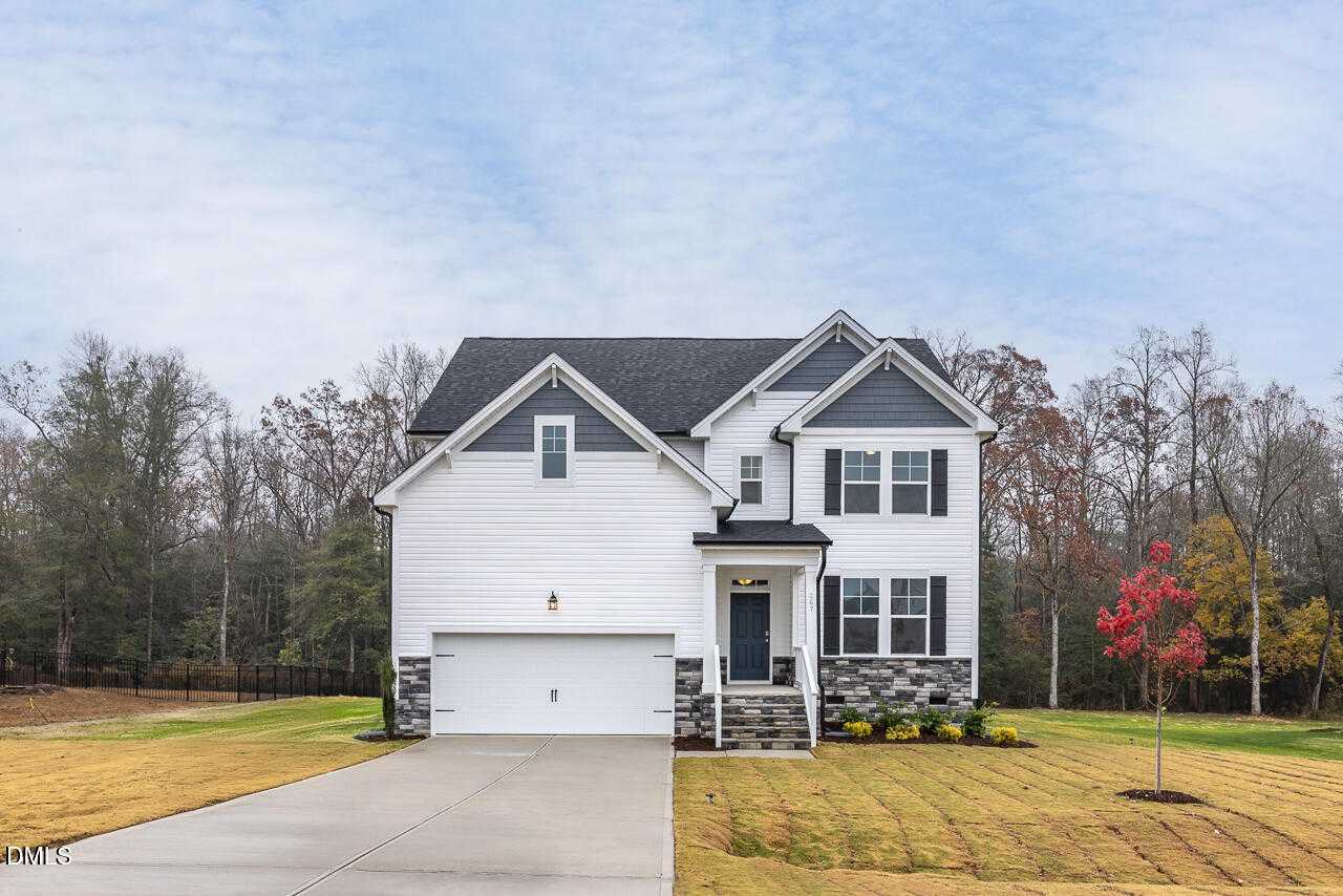 Modern 3-story white home with 2-car garage, front porch, and autumn trees in Wellers Knoll, Lillington, NC - Davidson Homes Hickory II A