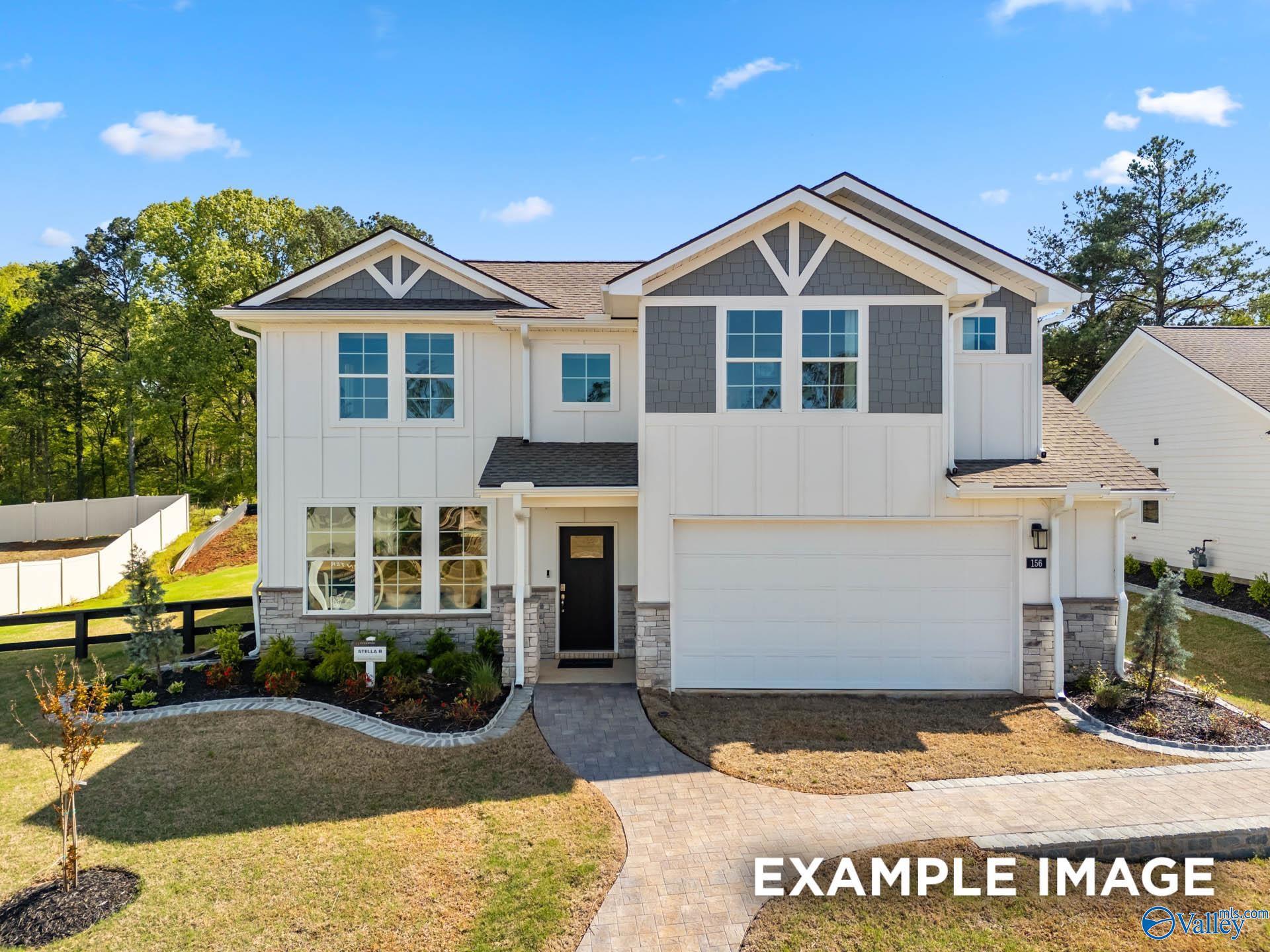 Modern two-story Davidson Homes The Stella exterior with white siding, two-car garage, and landscaped front yard in Evergreen Mill, Madison, Alabama