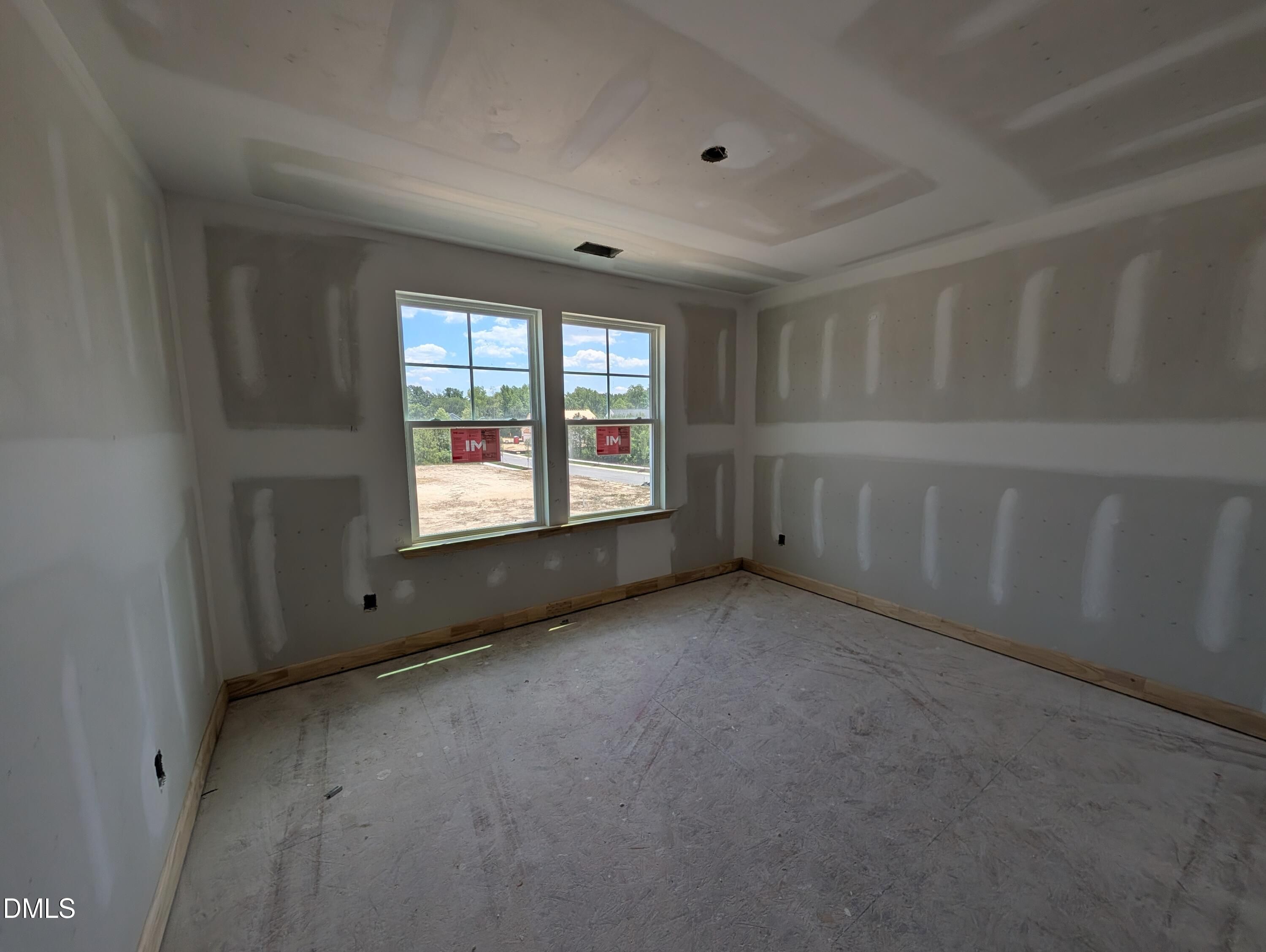 Unfinished bedroom with drywall in The Chestnut floor plan at Wendell Ridge, Wendell, NC by Davidson Homes.