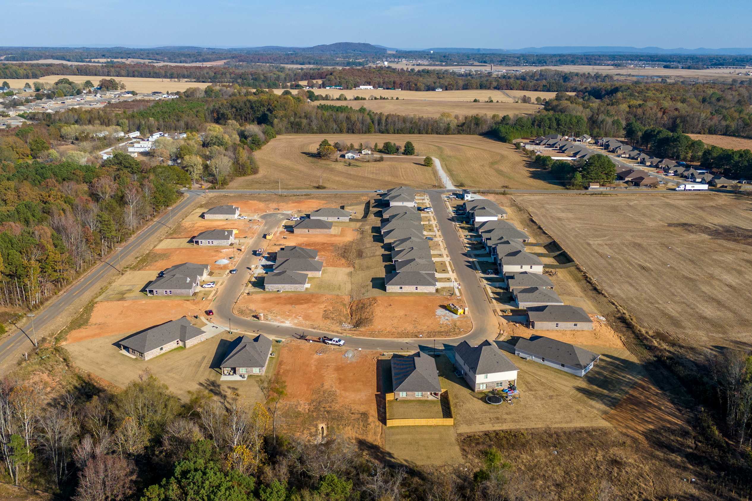 Aerial view of new homes at Mallard Landing in Athens Alabama surrounded by fields woods and farmland