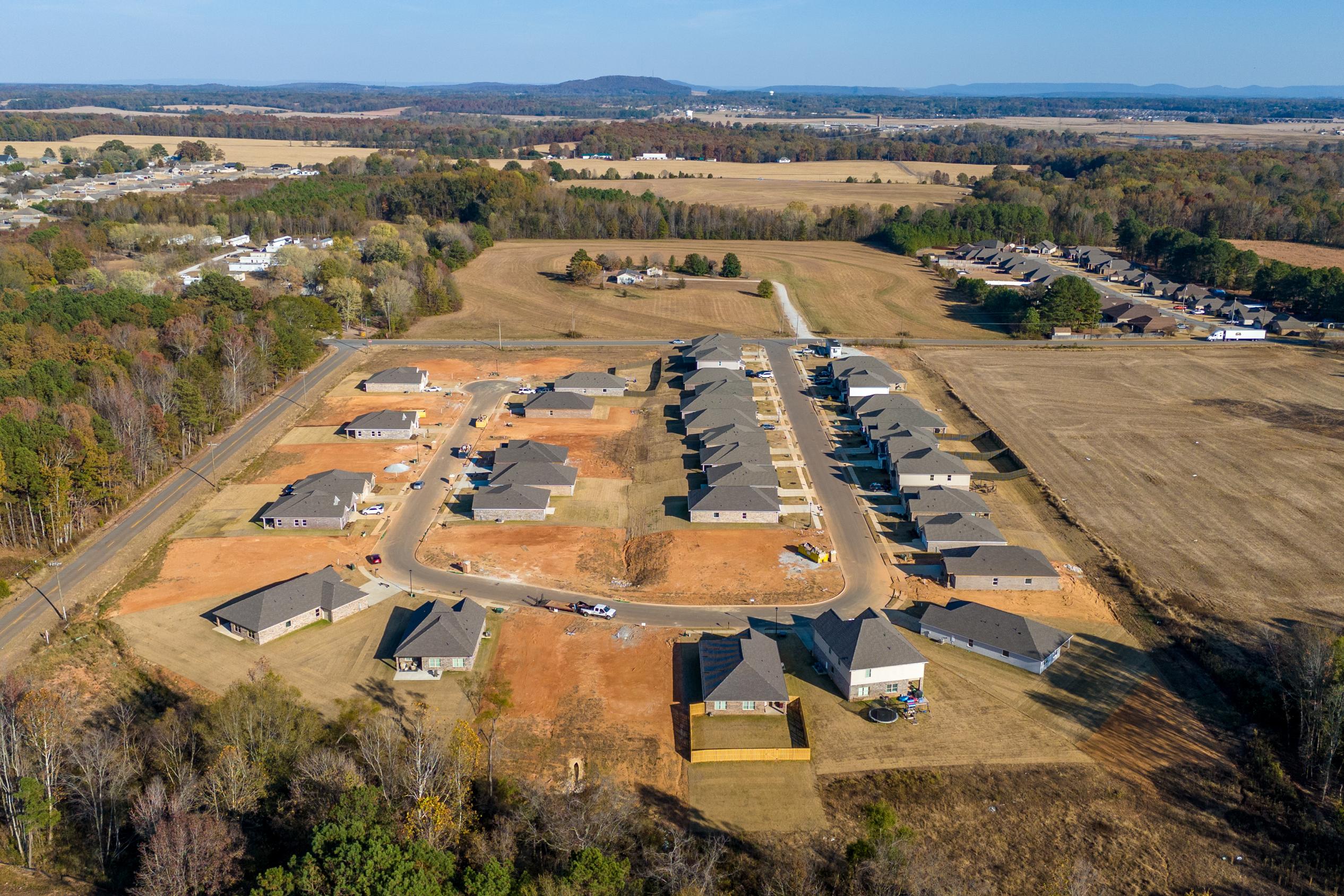 Aerial view of new homes at Mallard Landing in Athens Alabama surrounded by fields woods and farmland