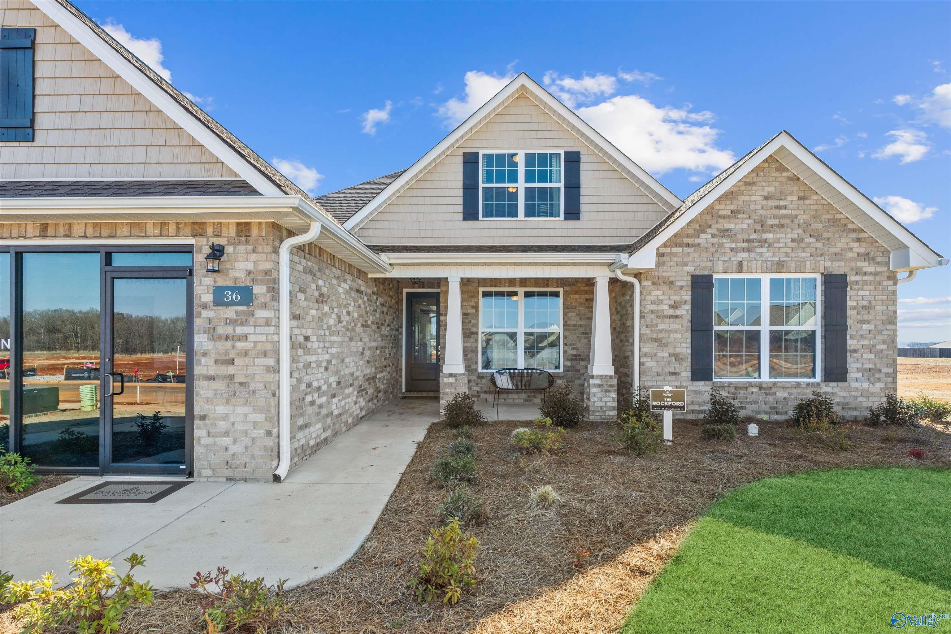 Single-story brick and siding exterior of The Rockford B with Bonus home by Davidson Homes in Barnett's Crossing, Madison, Alabama