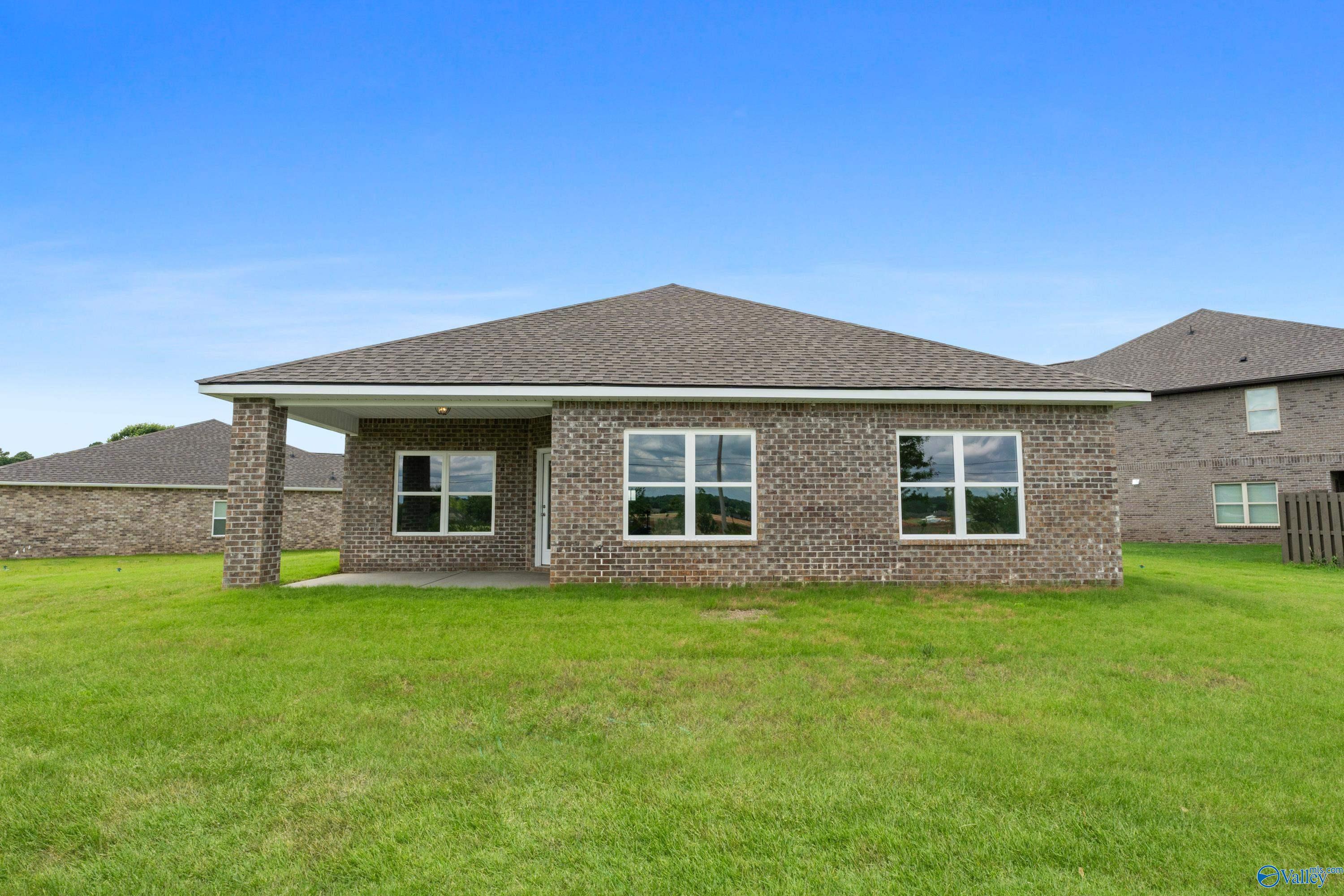 Brick exterior of The Everett B floor plan with covered patio in The Meadows, Athens, Alabama.