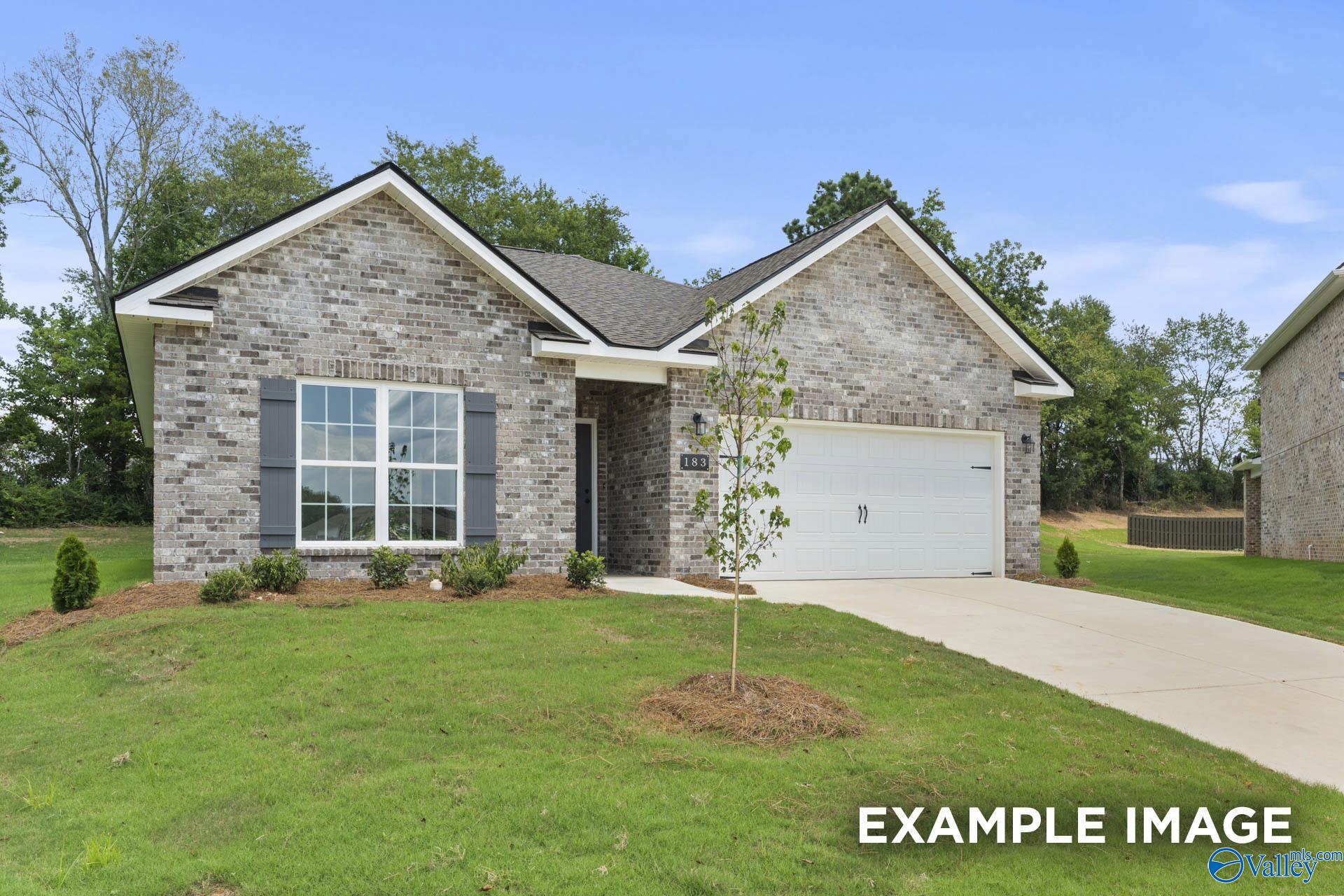 Modern brick single-story home with 2-car garage, white shutters, and landscaped lawn in Clearview, Hazel Green, Alabama - Davidson Homes The Asheville C