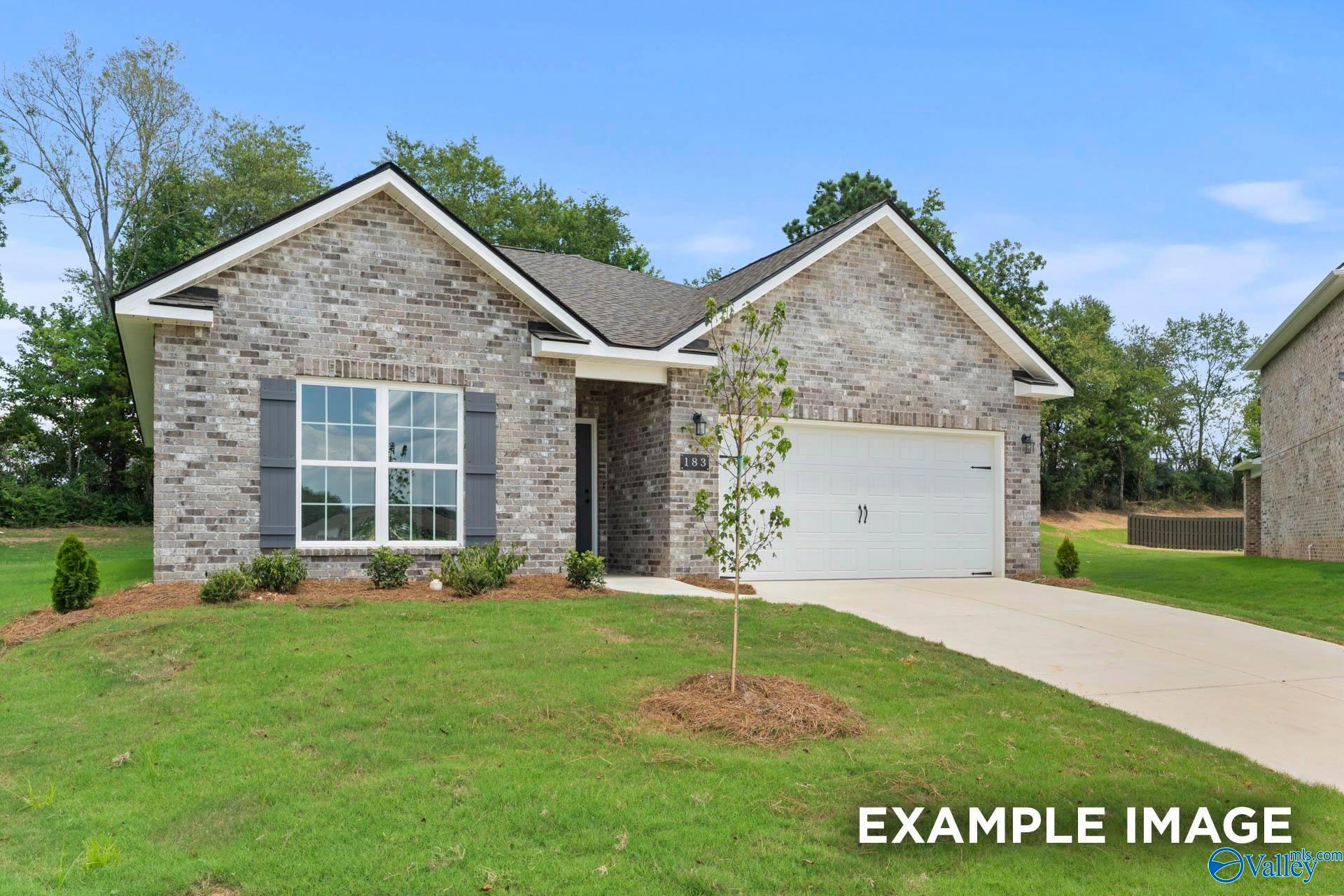 Modern brick single-story home with 2-car garage, white shutters, and landscaped lawn in Clearview, Hazel Green, Alabama - Davidson Homes The Asheville C