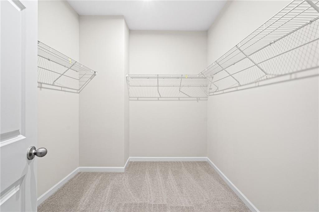 Walk-in closet with wire shelving in The Glenwood A floor plan at Wehunt Meadows in Hoschton, Georgia.