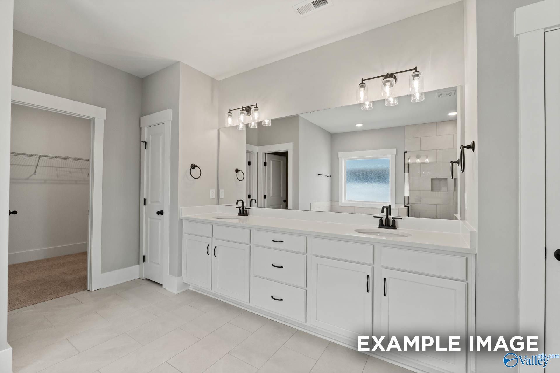 Master bathroom with dual vanity and walk-in closet in The Finleigh floor plan by Davidson Homes in Briercreek, Meridianville