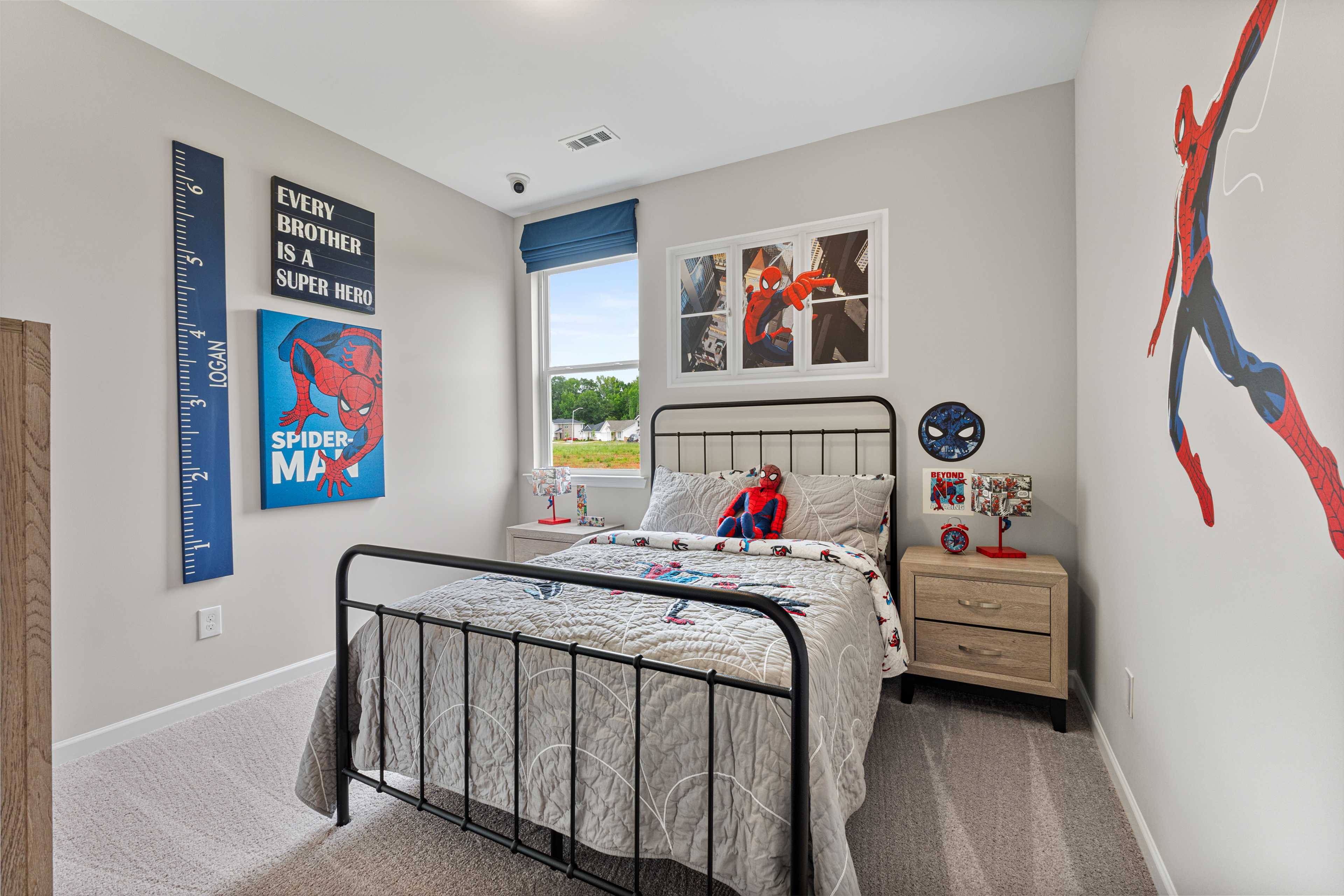 Spider-Man themed boy's bedroom in Forest Glen Hazel Green AL with twin metal bed posters and growth chart