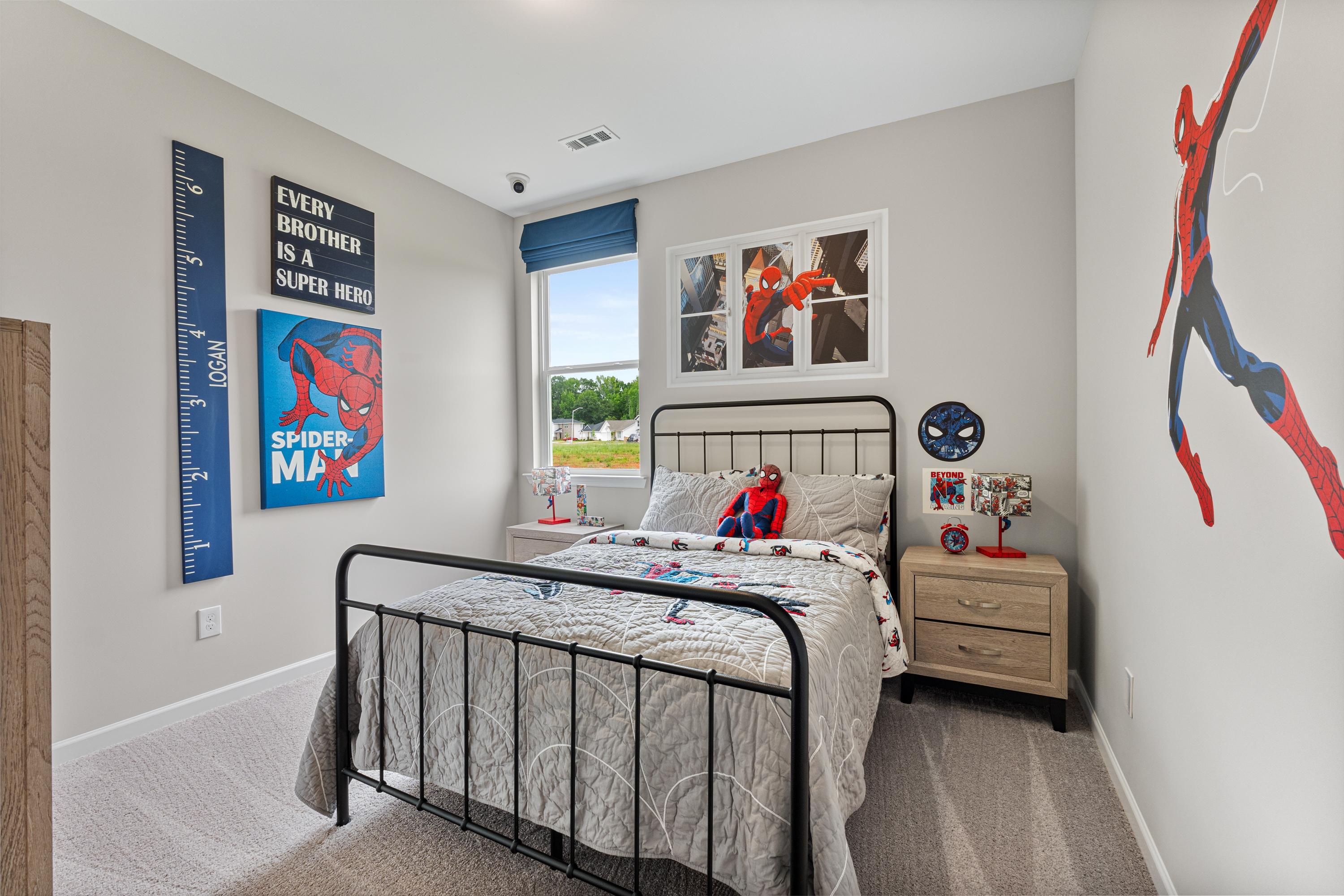 Spider-Man themed boy's bedroom in Forest Glen Hazel Green AL with twin metal bed posters and growth chart