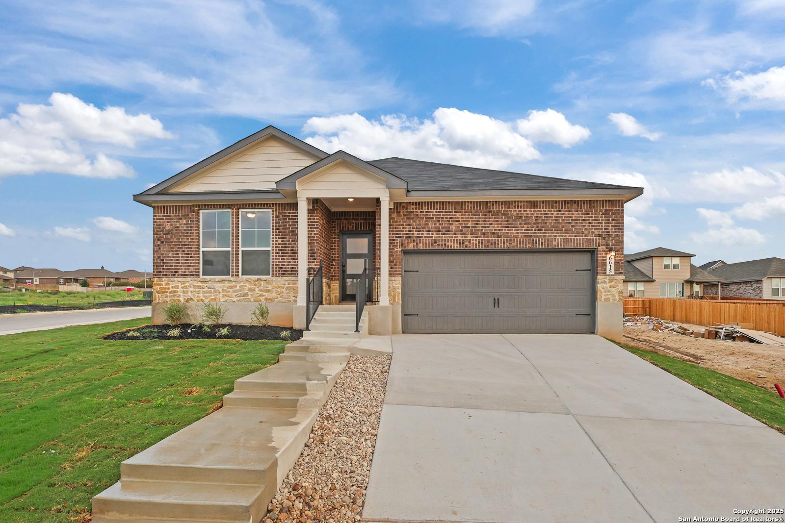 Modern 1-story brick home with 2-car garage, covered entry, and landscaped yard in Comanche Ridge, San Antonio, Texas - Davidson Homes The Daphne K