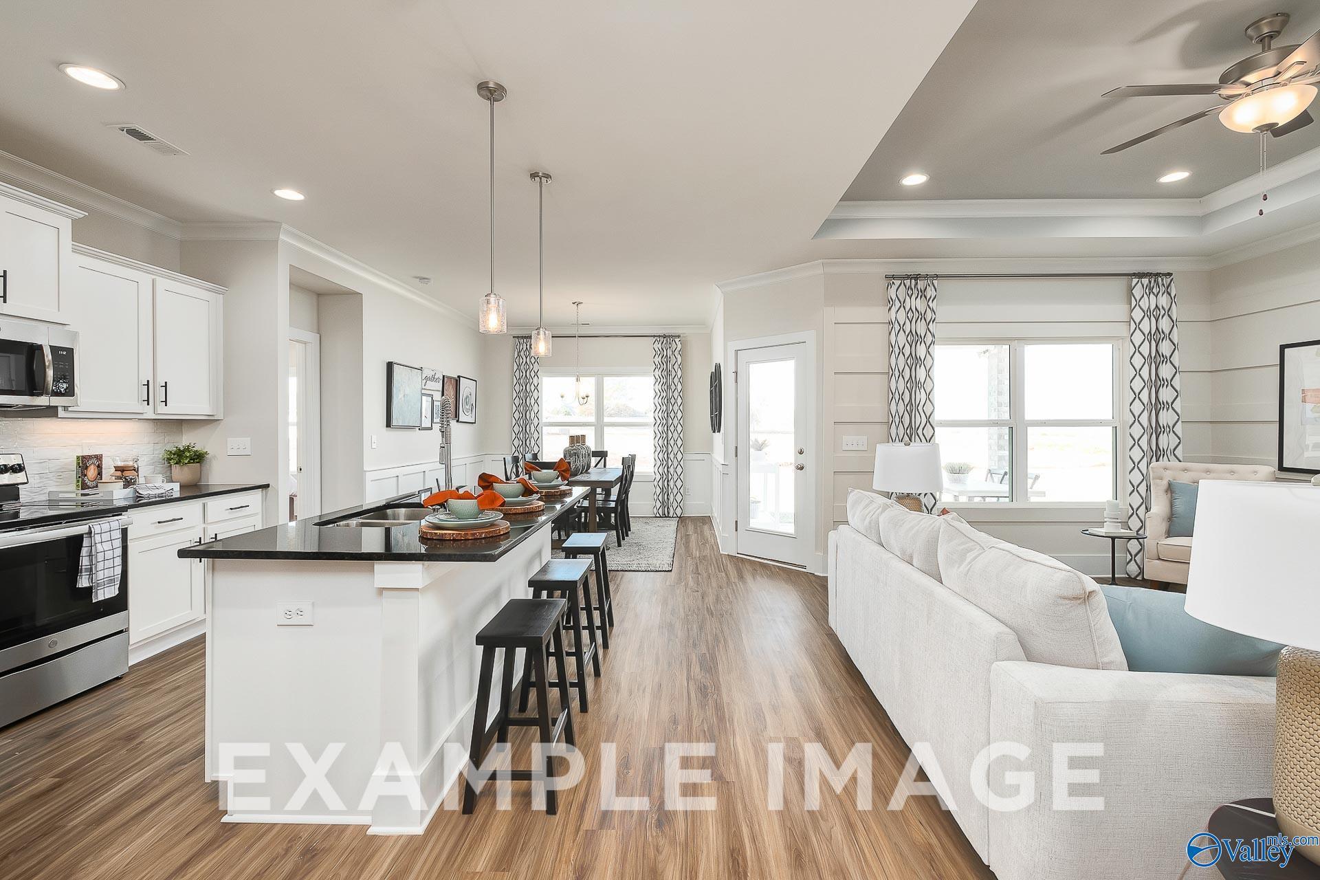 Open-concept kitchen and living area in The Everett B floor plan, The Meadows, Athens, Alabama by Davidson Homes.