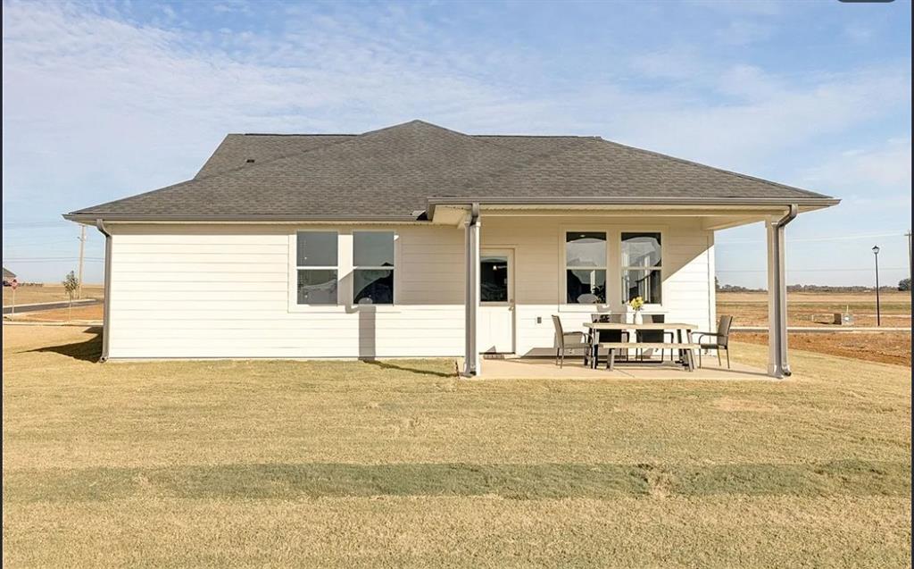 White single-story Davidson Homes Aurora D with covered patio and dining area in Anderson Lakes, Opelika, Alabama
