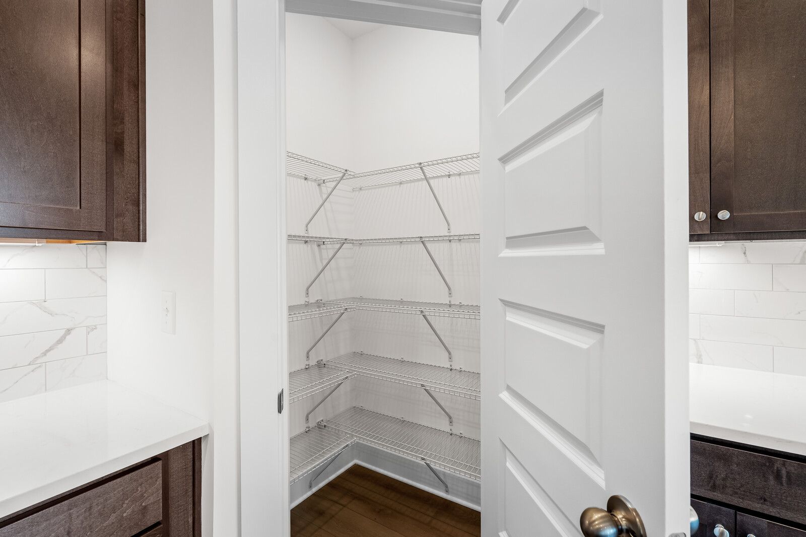 Spacious walk-in pantry with wire shelving in The Cottonwood floor plan by Davidson Homes in Gallatin, Tennessee.