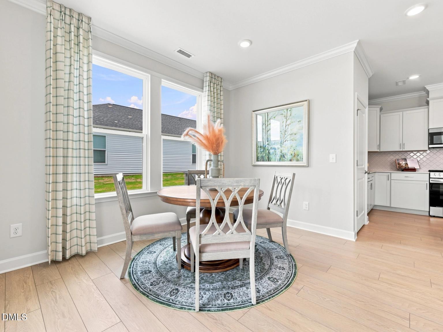 Bright breakfast nook with dining table in The Daphne C floor plan at Woodland Crossing, Zebulon, North Carolina.