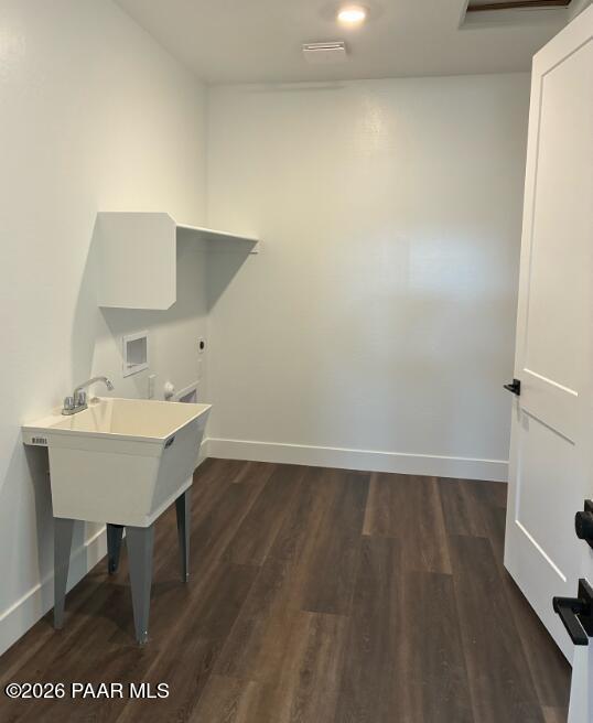 Laundry room with utility sink and shelving in The Durango II G floor plan at South Ranch, Prescott, Arizona.