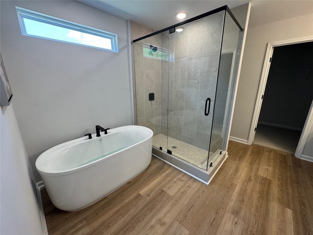 Modern master bathroom with soaking tub and glass-enclosed shower in The Sinclair C floor plan at Greene Farm, Cartersville.