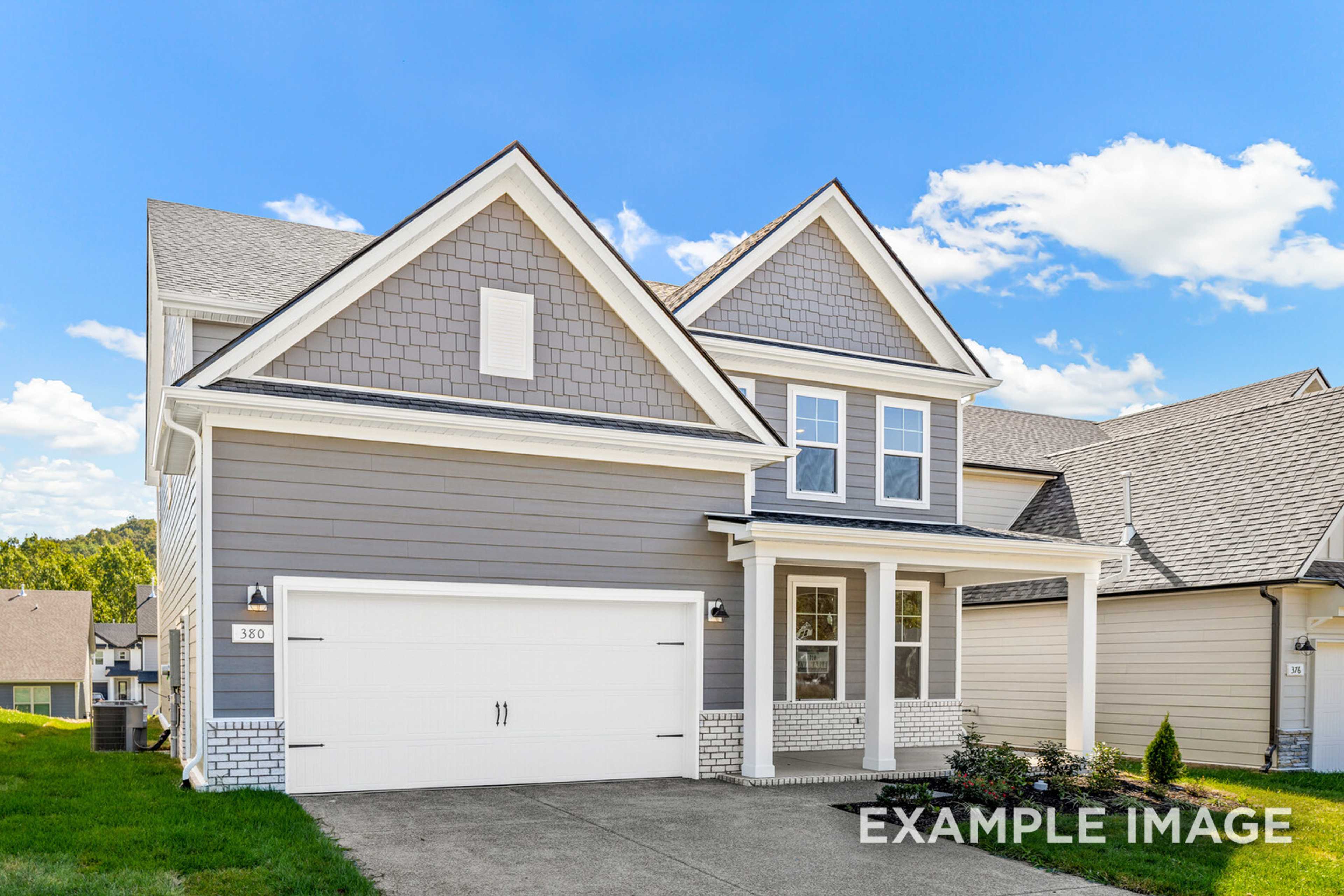 Two-story Henry C home elevation with gray siding, gabled roof, two-car garage, and front porch in Mt. Juliet