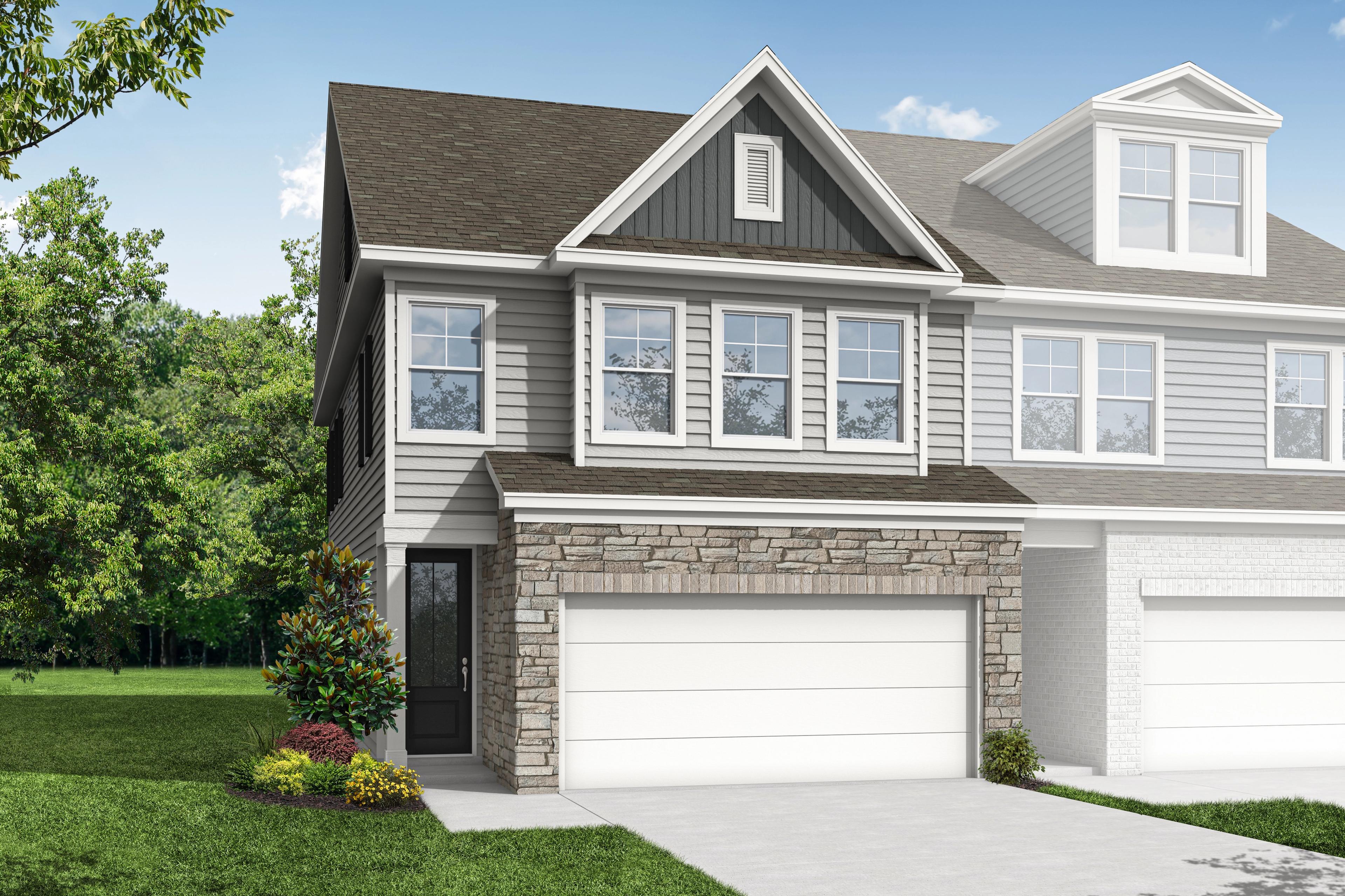 Modern townhome exterior at Hemingway in Cumming Georgia with gray siding stone accents and two-car garage