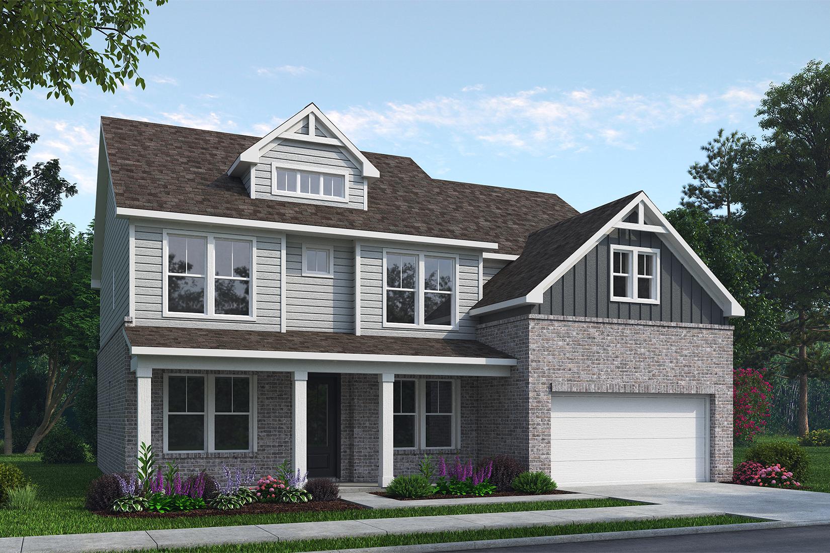 Two-story Danbury K home elevation by Davidson Homes: brick and gray siding exterior, front porch, two-car garage, lush landscaping in Buford, GA