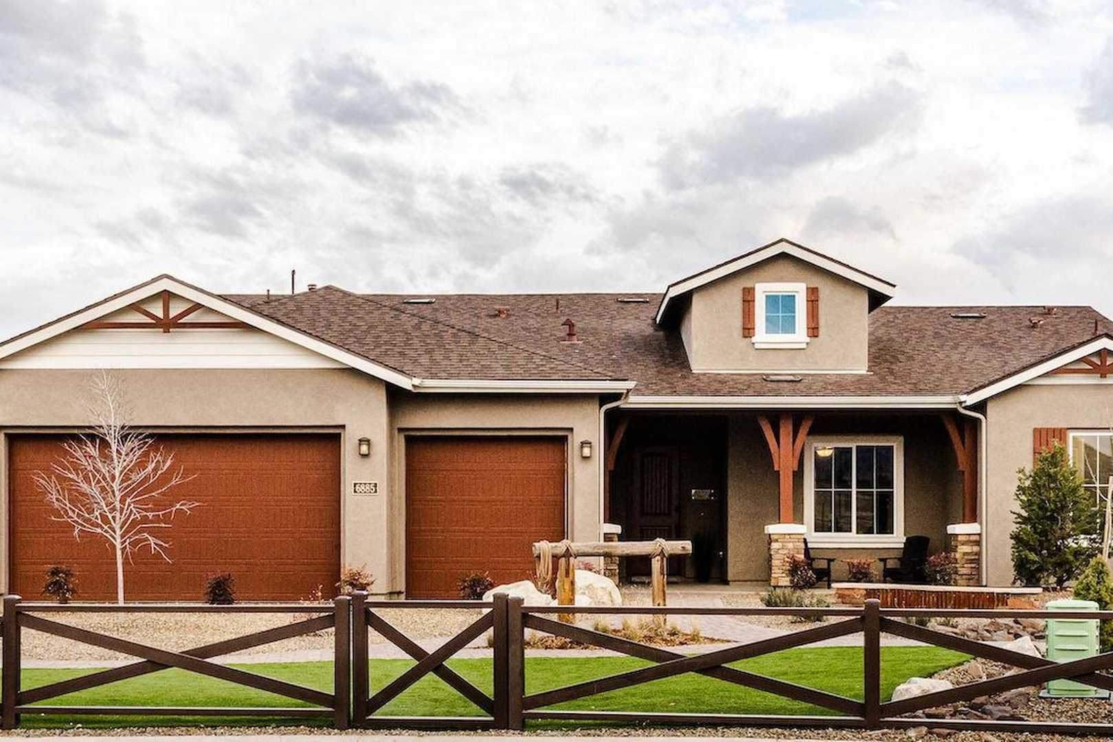 Contemporary ranch home exterior in Westwood, Prescott AZ by Davidson Homes with covered porch, garage and split-rail fence