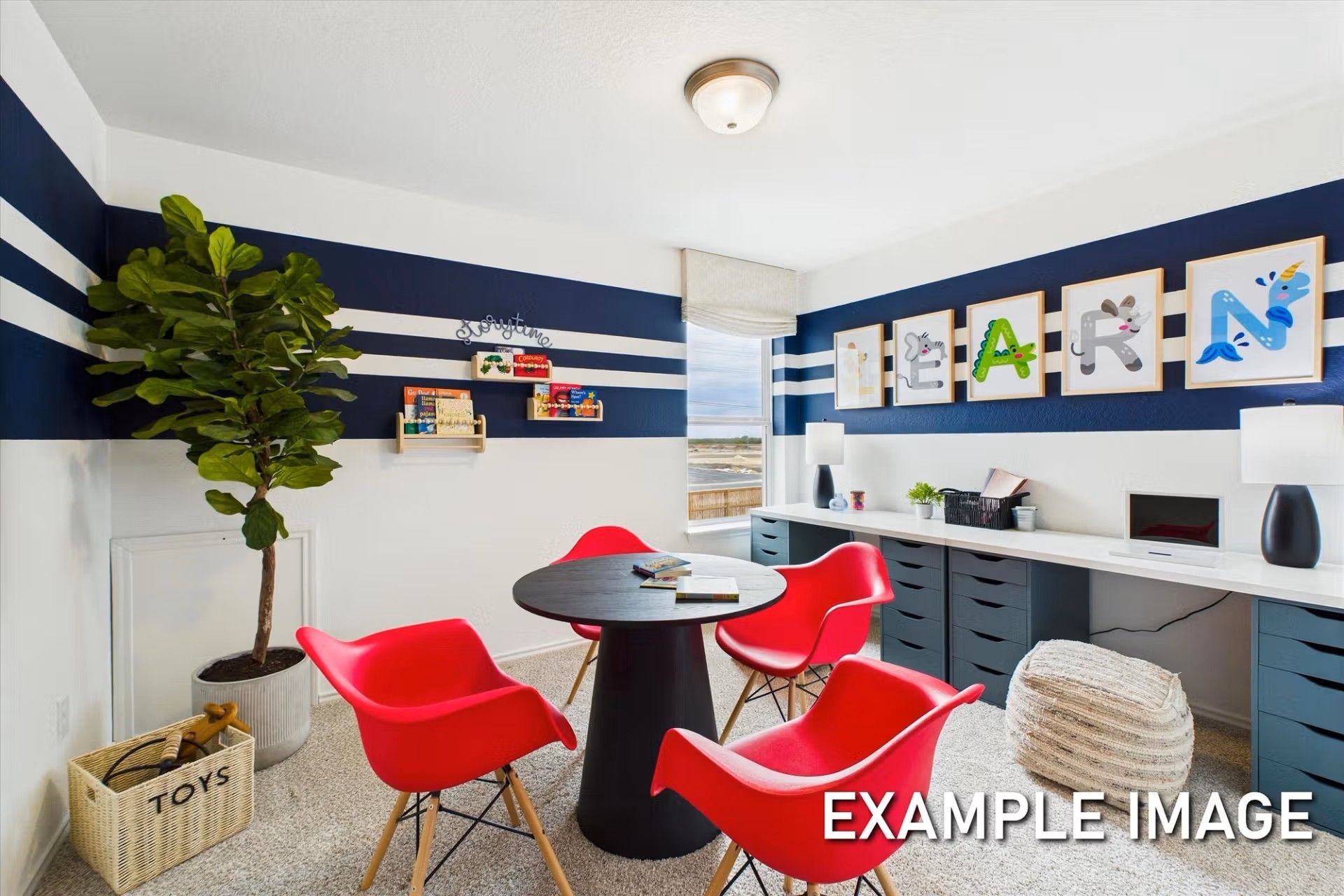 Playful kids' study room with red chairs, activity table, and built-in desk in a Davidson Homes Brazos E floor plan home.