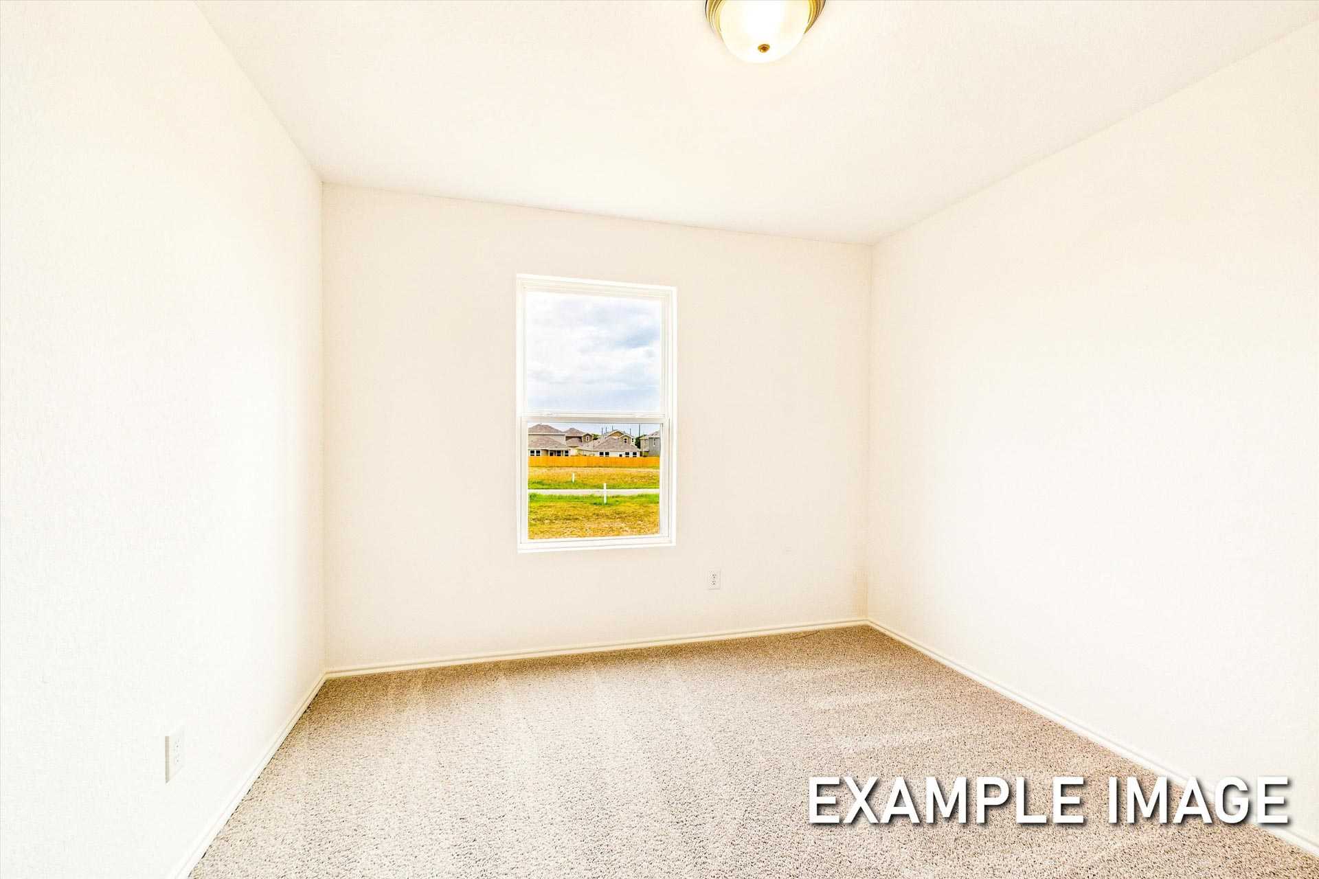 Spacious empty bedroom in The Trinity B featuring beige carpet, white walls, and window view of San Antonio suburbs