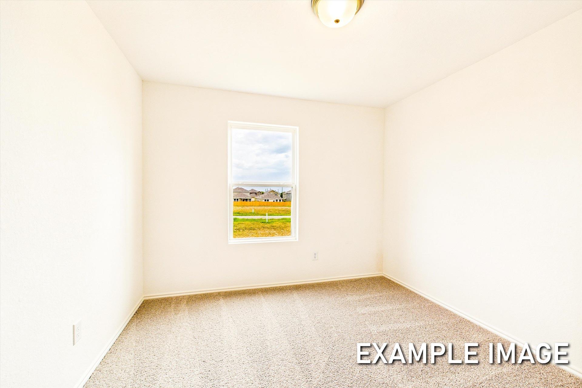Spacious empty bedroom in The Trinity B featuring beige carpet, white walls, and window view of San Antonio suburbs
