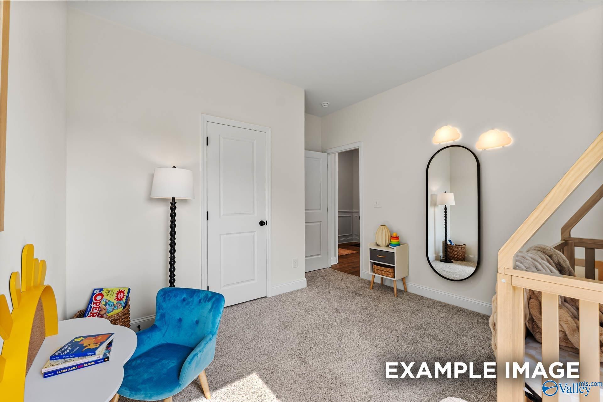 Cozy children's bedroom with wooden crib, blue armchair, toys and mirror in 3-bedroom The Franklin home, Huntsville, Alabama