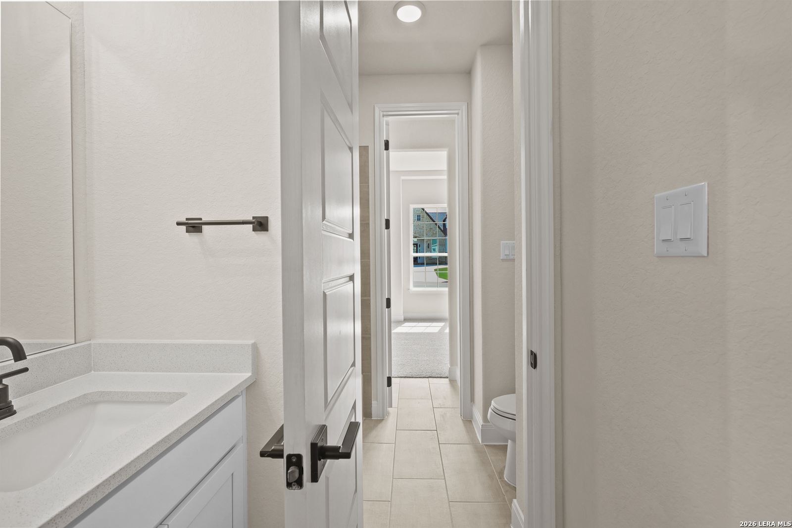 Modern bathroom with white vanity and tile flooring in The Summerlin B floor plan by Davidson Homes, Potranco Oaks.