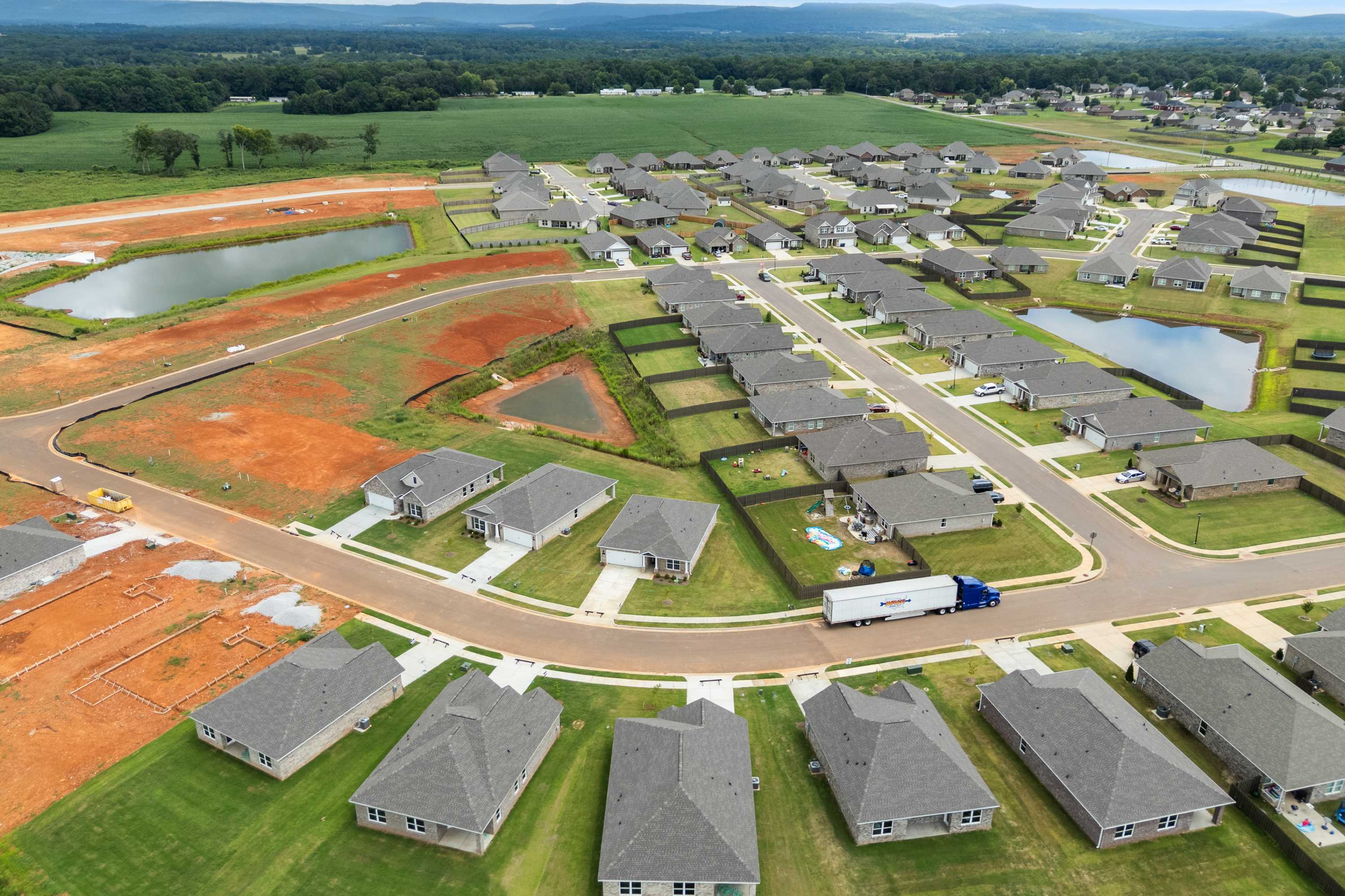 Aerial view of Heritage Lakes neighborhood in New Market Alabama with new homes ponds construction sites and green spaces by Davidson Homes