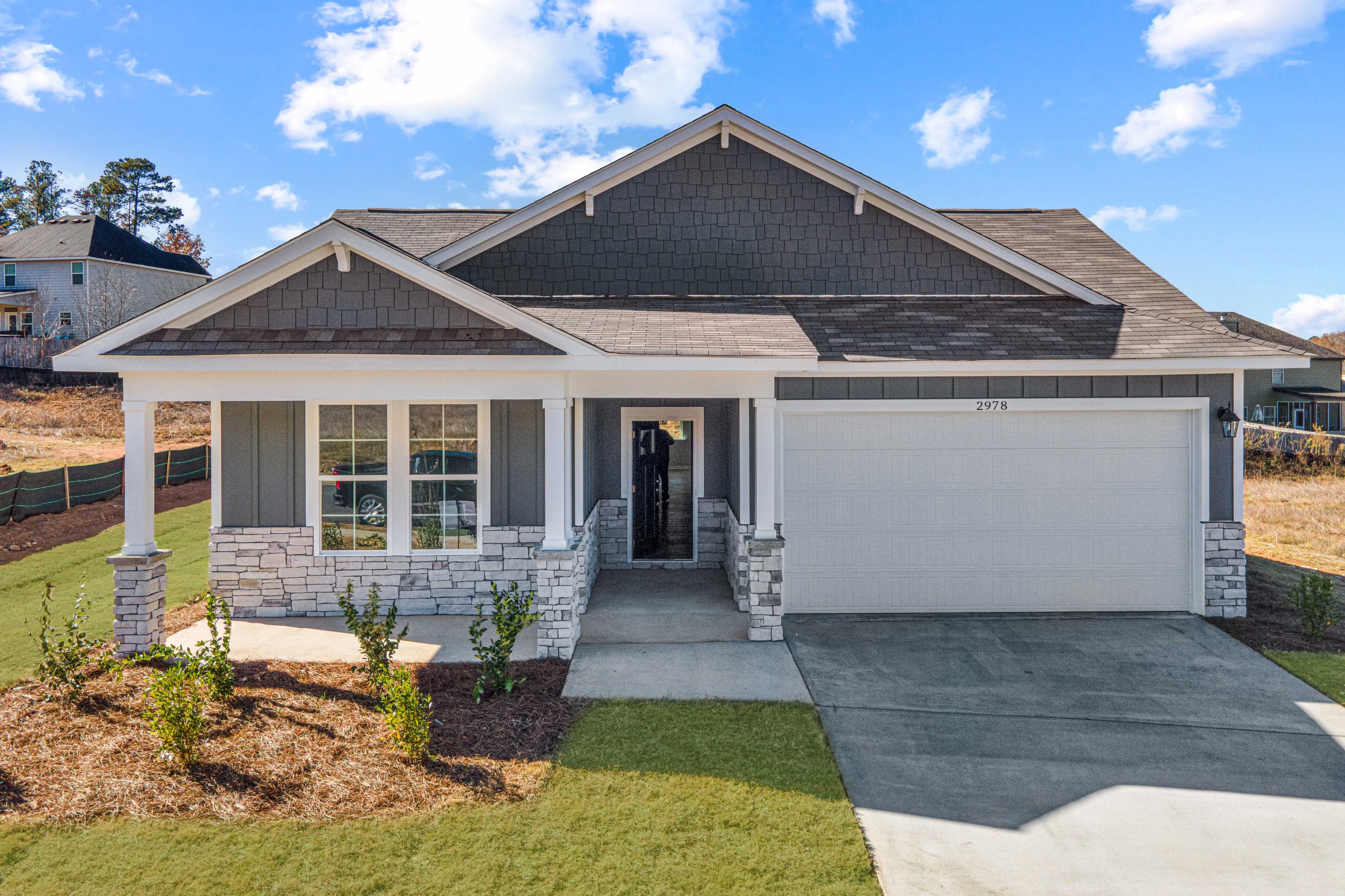 Modern farmhouse style home exterior at Links Crossing in Auburn Alabama with covered porch and attached garage