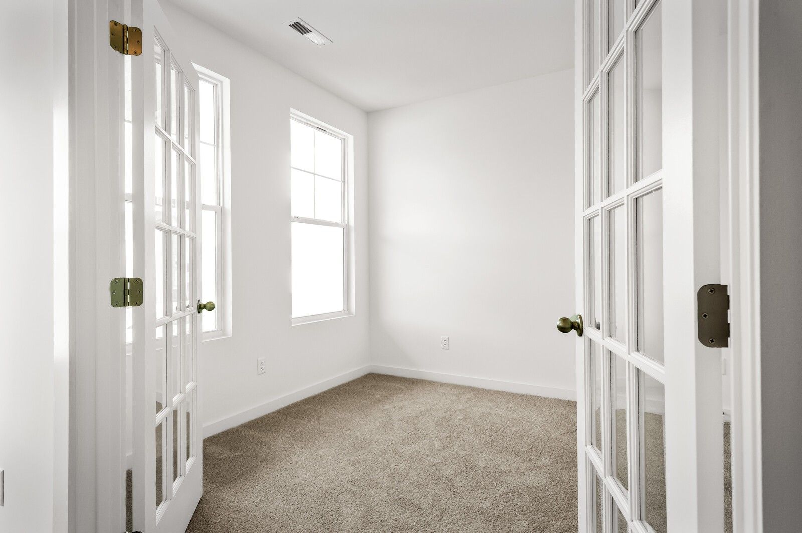 Bright flex room with French doors and carpeted flooring in The Logan C floor plan at Calista Farms, White House, TN.