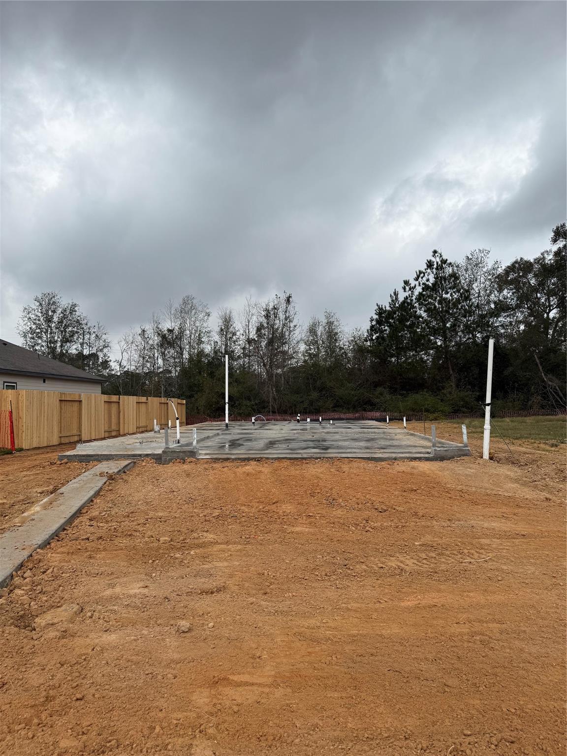 Freshly poured concrete slab foundation for Davidson Homes Colorado G in Caney Creek Place, Conroe, Texas
